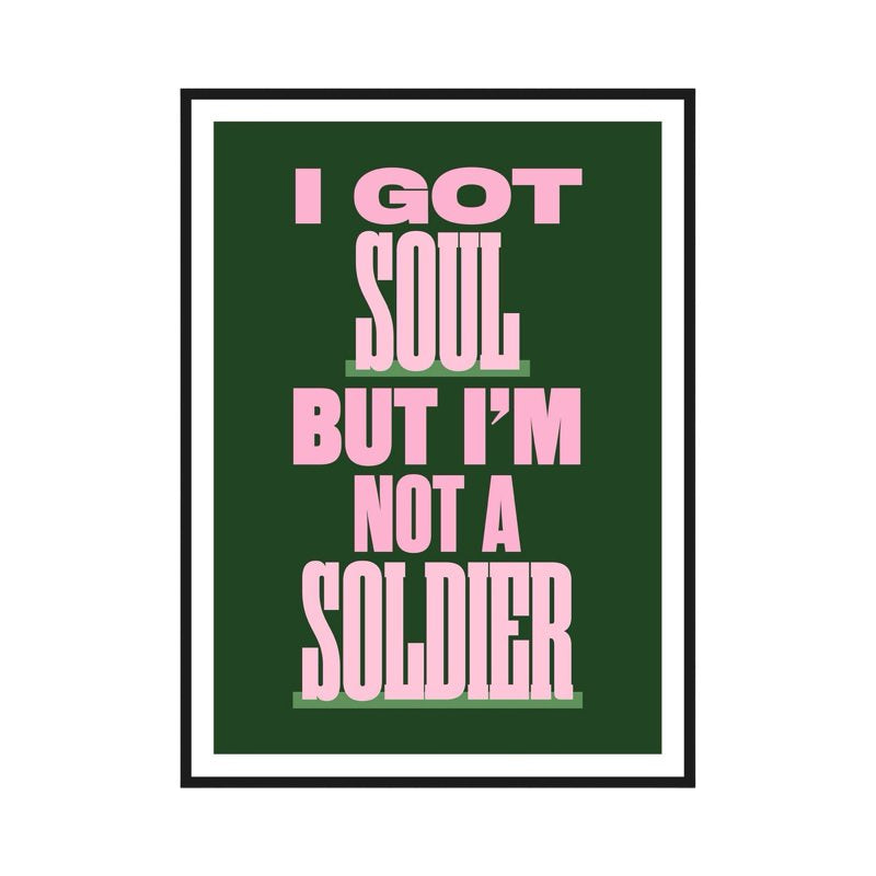 Typography print of the lyric 'I Got Soul but I'm not a Soldier' from the song All These Things That I've Done by The Killers. The text is written in pink uppercase lettering against a deep green background with an off-white border.