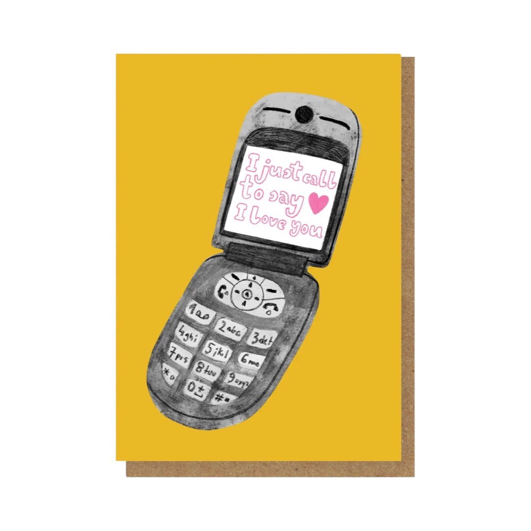 ‘I just call to say I love you’ card featuring an illustration of a flip mobile phone on a yellow background.