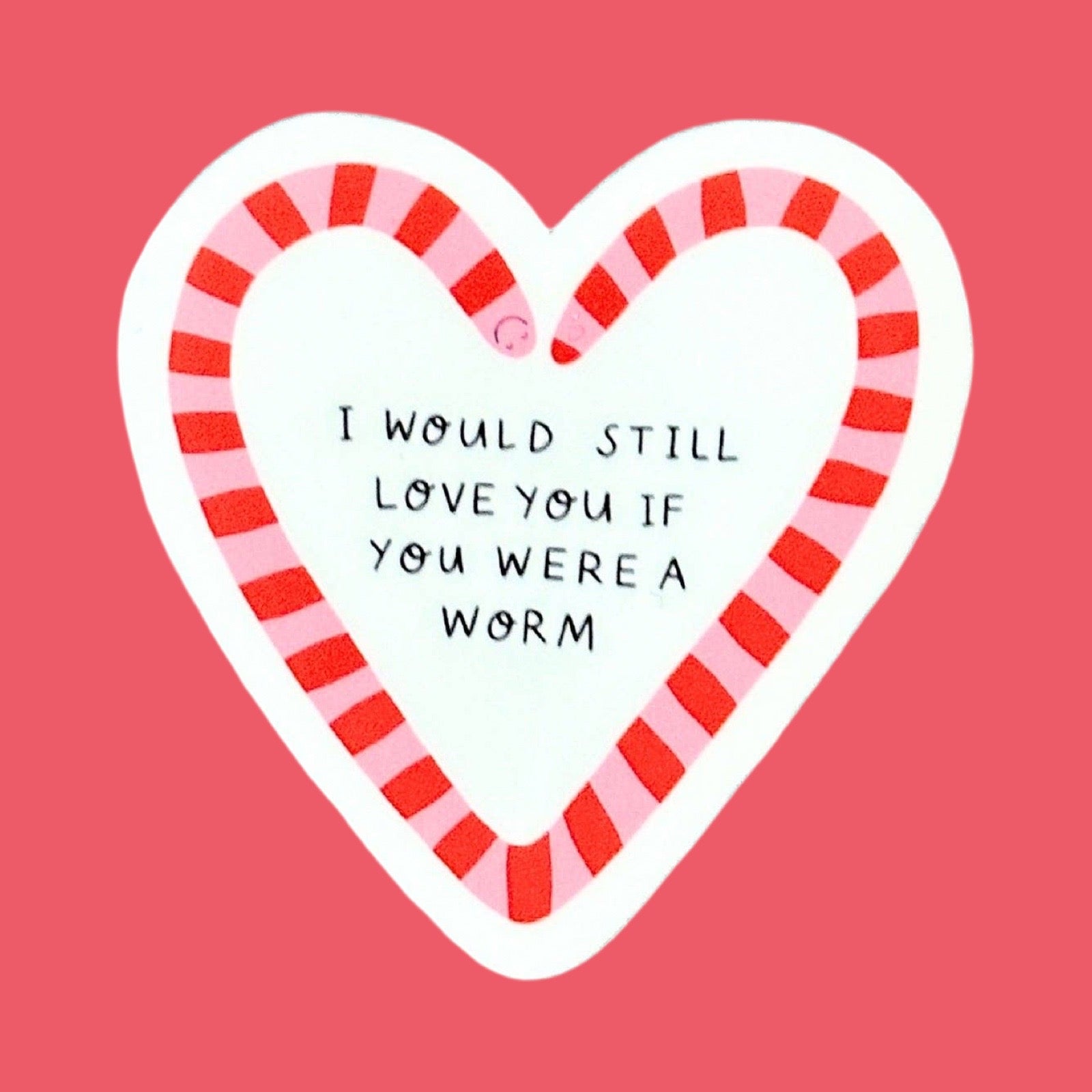 A heart-shaped sticker with a red and pink striped worm border and handwritten style black text that reads, 'I WOULD STILL LOVE YOU IF YOU WERE A WORM' on a red background.
