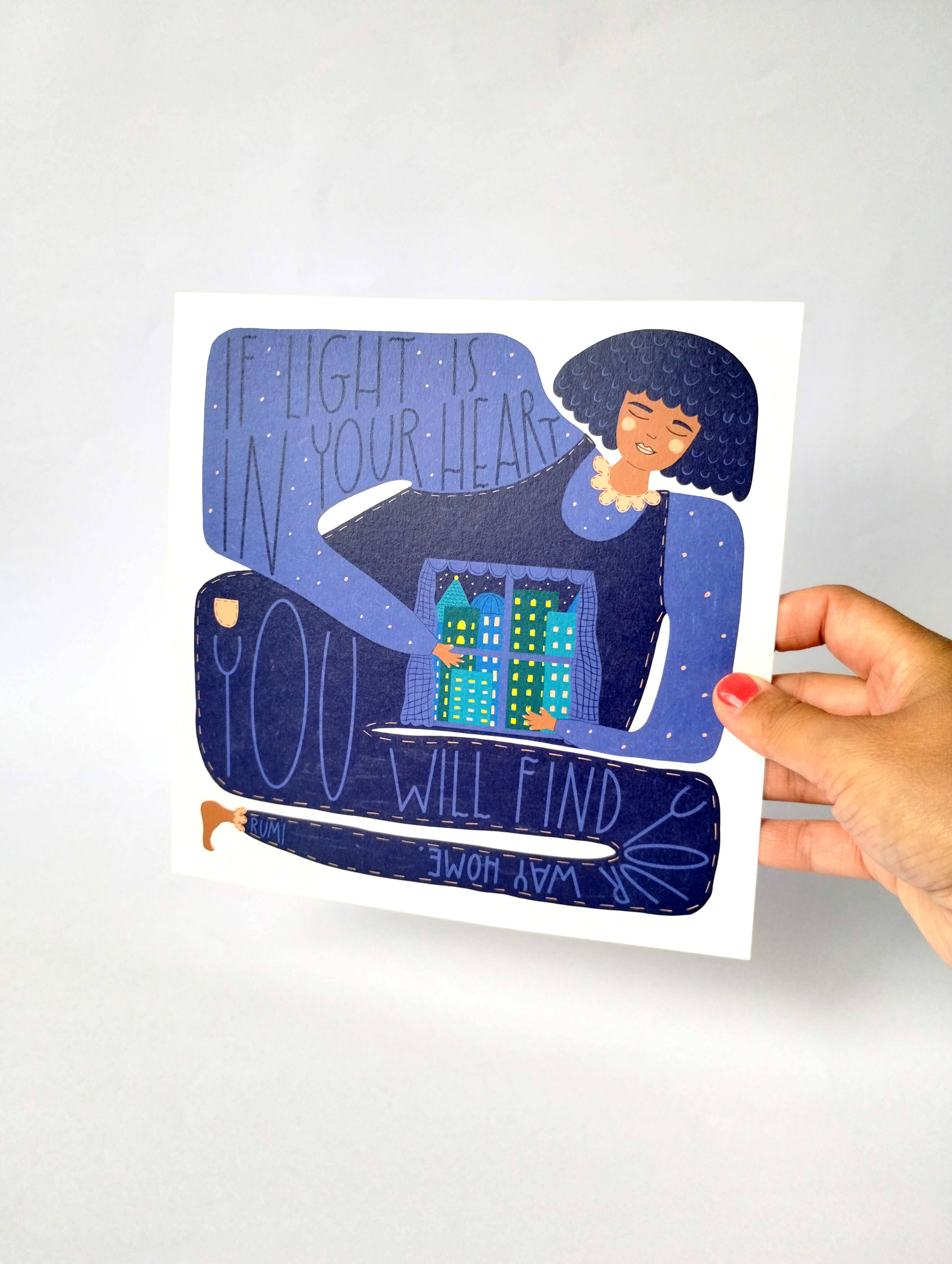 Illustrated print with a person holding a home and text, held by a hand on a white background.