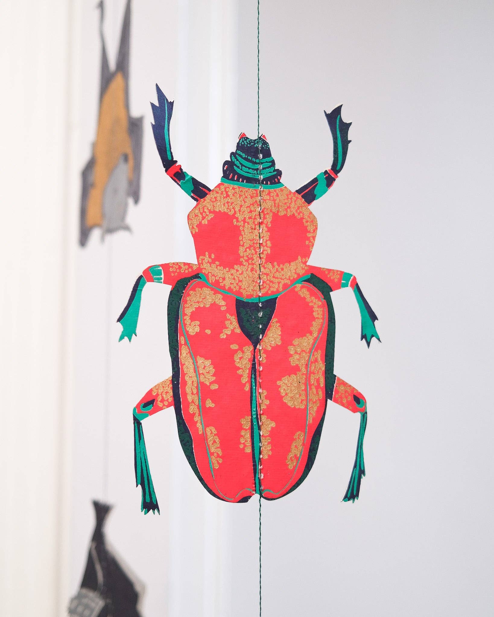 Colorful beetle illustration on a white background.