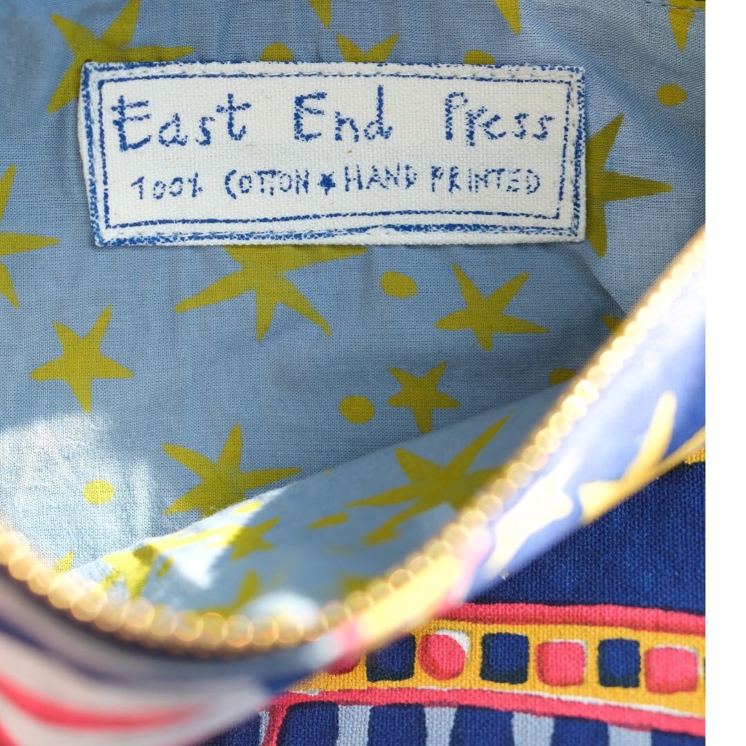 The inside of the elephant fabric pouch with light blue lining and yellow stars.
