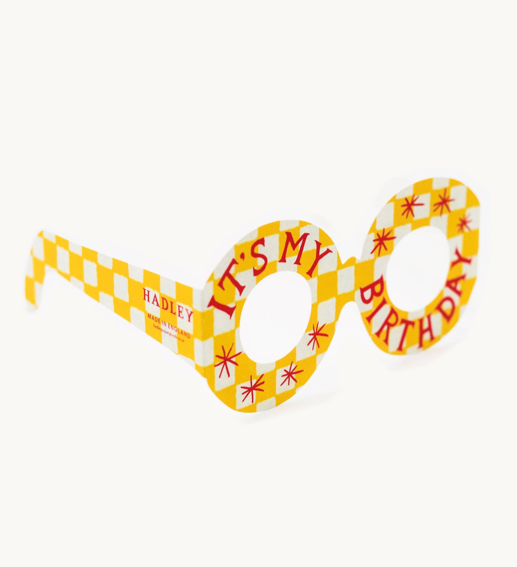 Birthday-themed novelty glasses with checkered design and text on a white background.