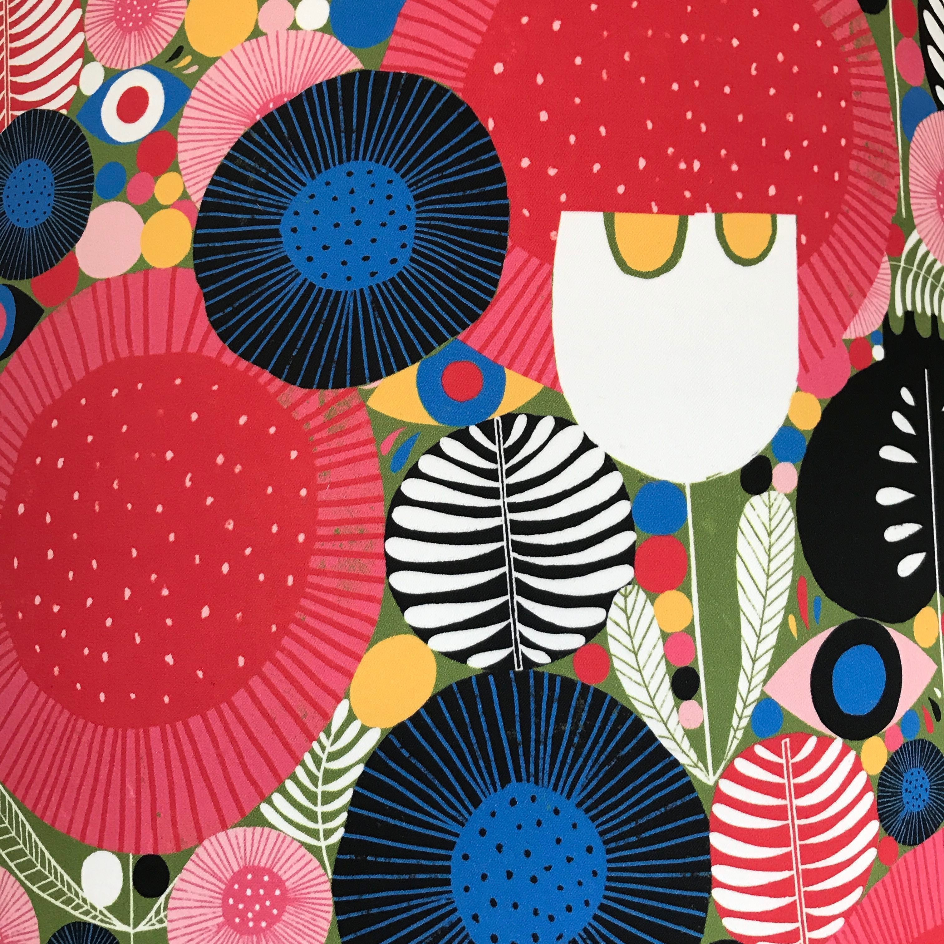 cotton sateen mid-century inspired fabric with various flowers and leaves in reds, white, yellow, red, pinks, greens and blues.