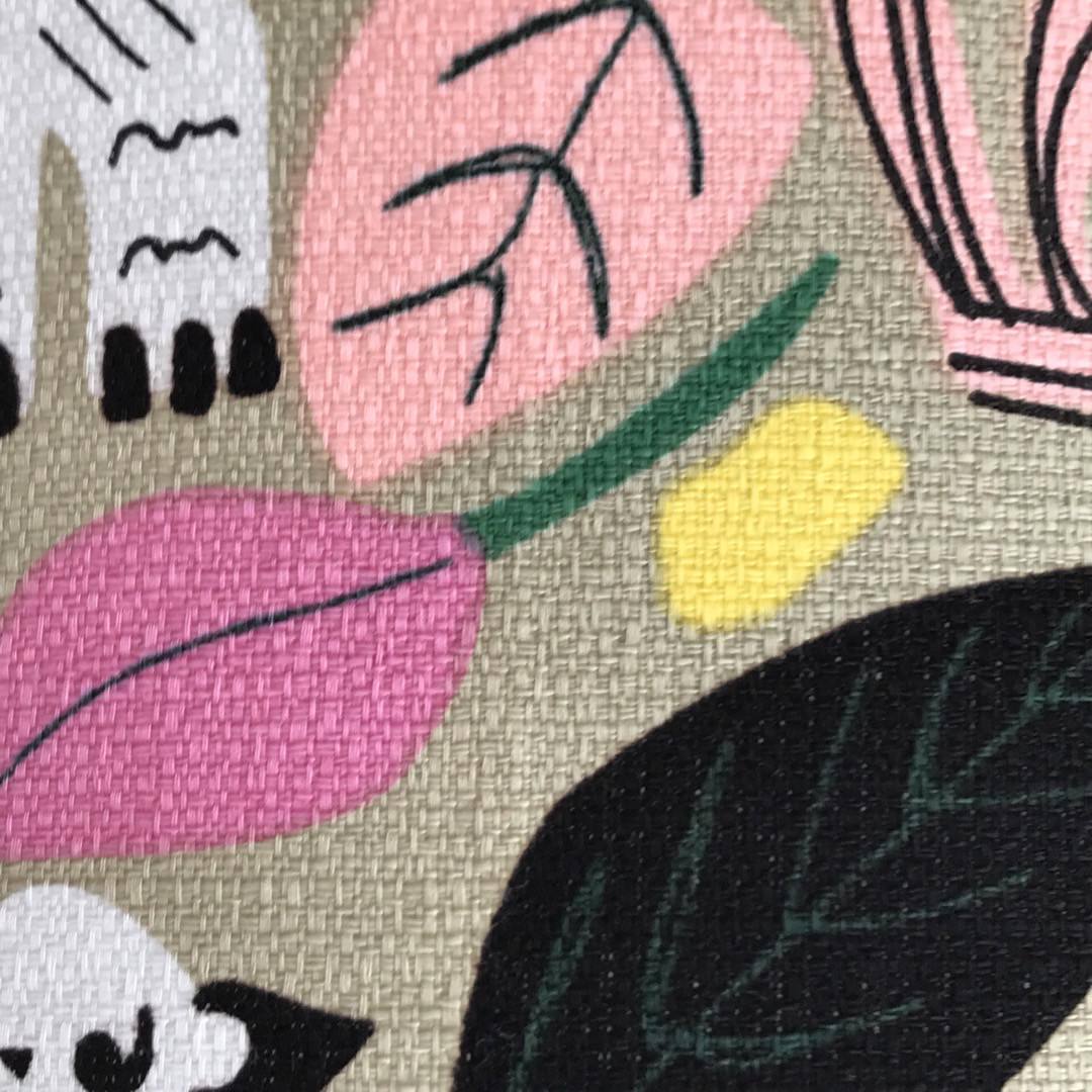 Barkcloth fabric with black and white jungle animals and colourful leaves on a grey background