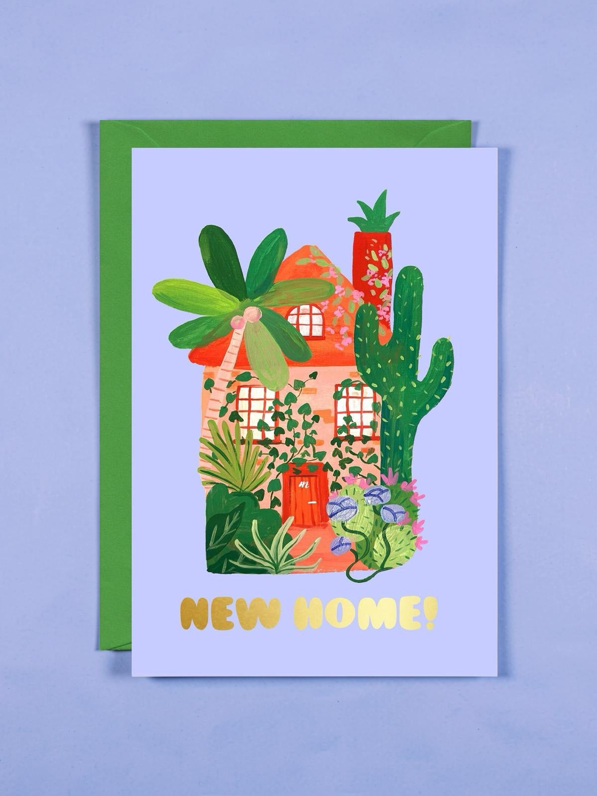 Greeting card with a house and cactus illustration and 'New Home!' text on a blue background.