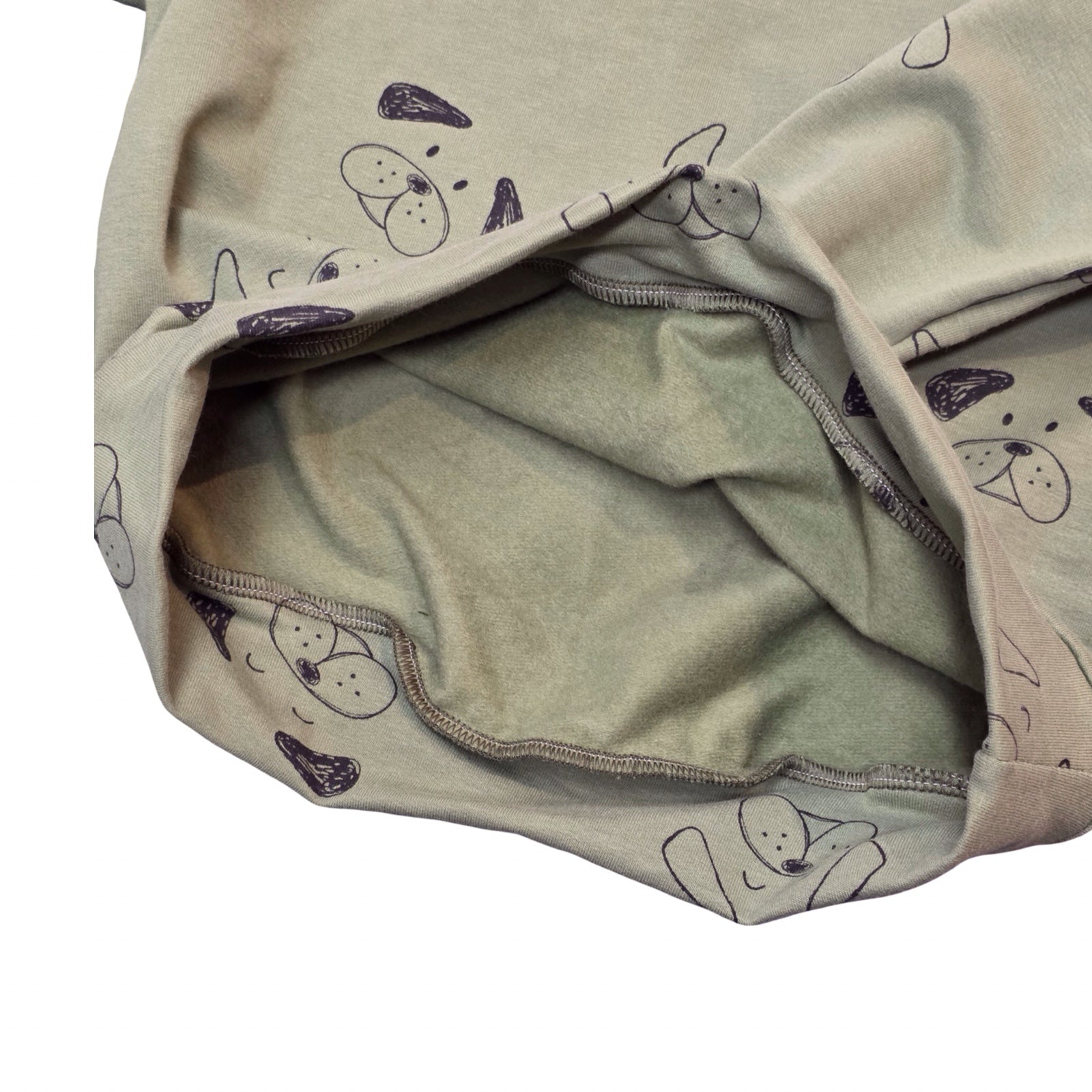 Open sweatshirt with a pattern of dog faces on a white background.