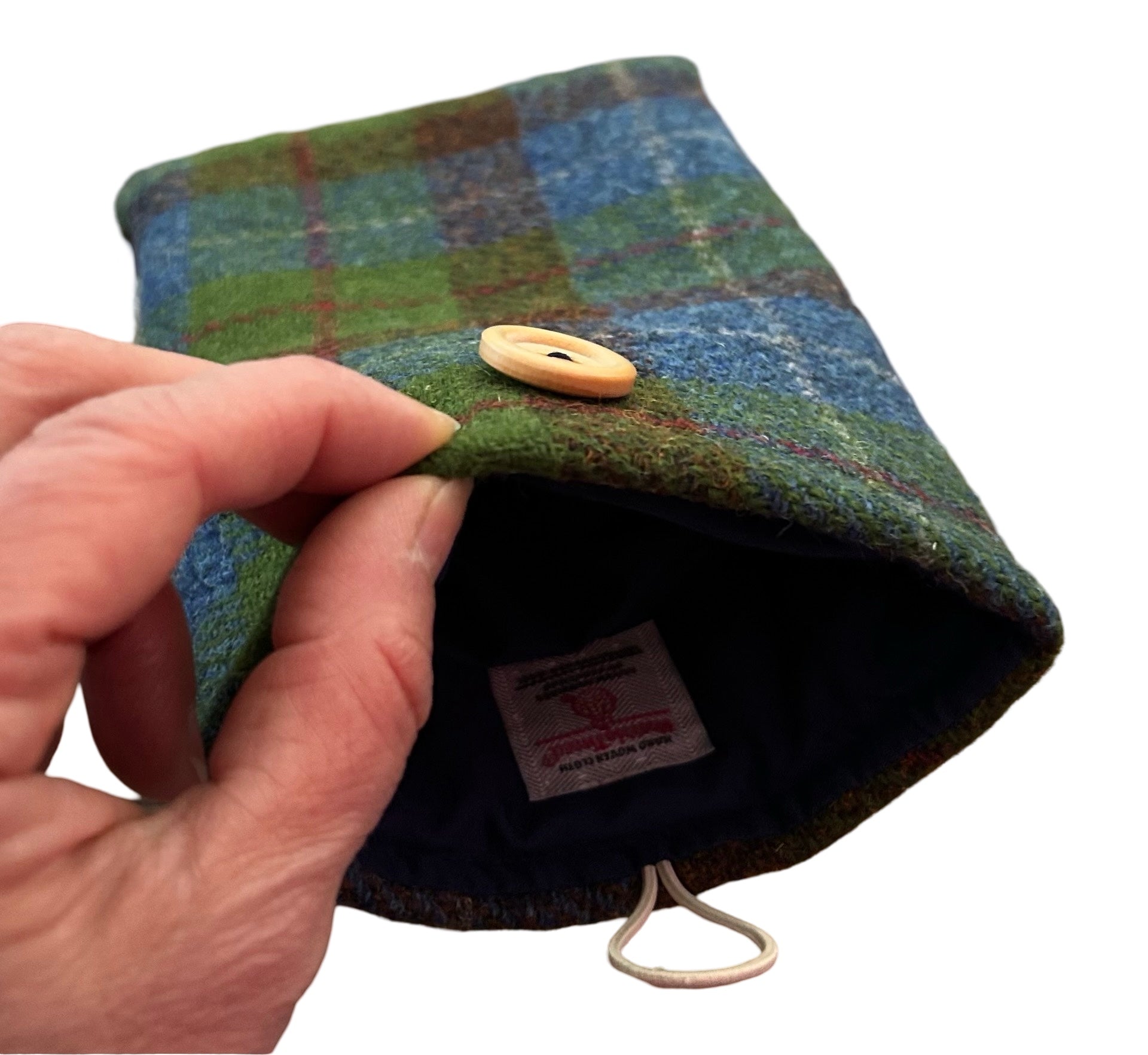 Showing the inside of the blue and green Harris tweed Kindle or E Reader sleeve. There is a Harris tweed orb label sewn into the lining.