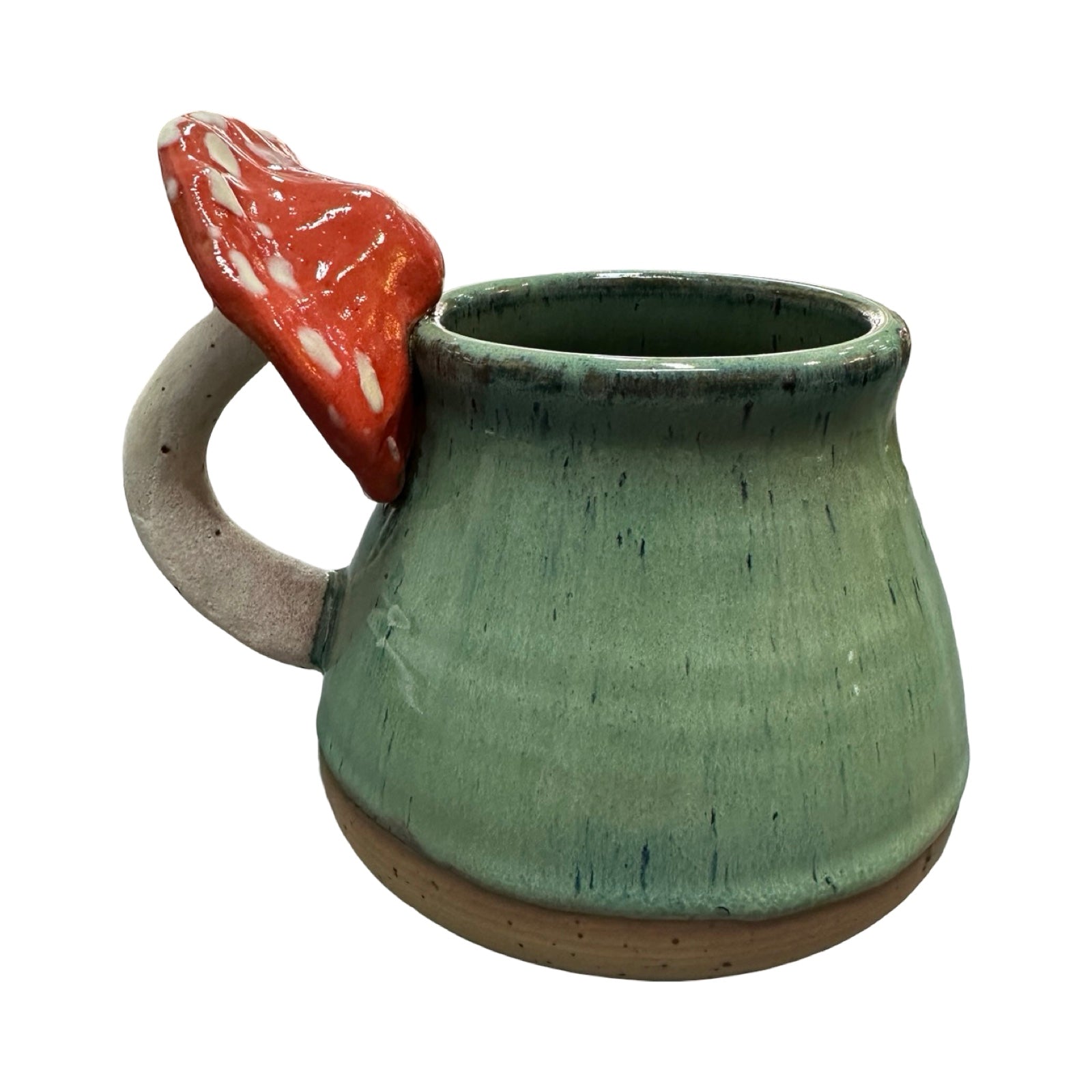 Green ceramic mug with a red mushroom handle on a white background.