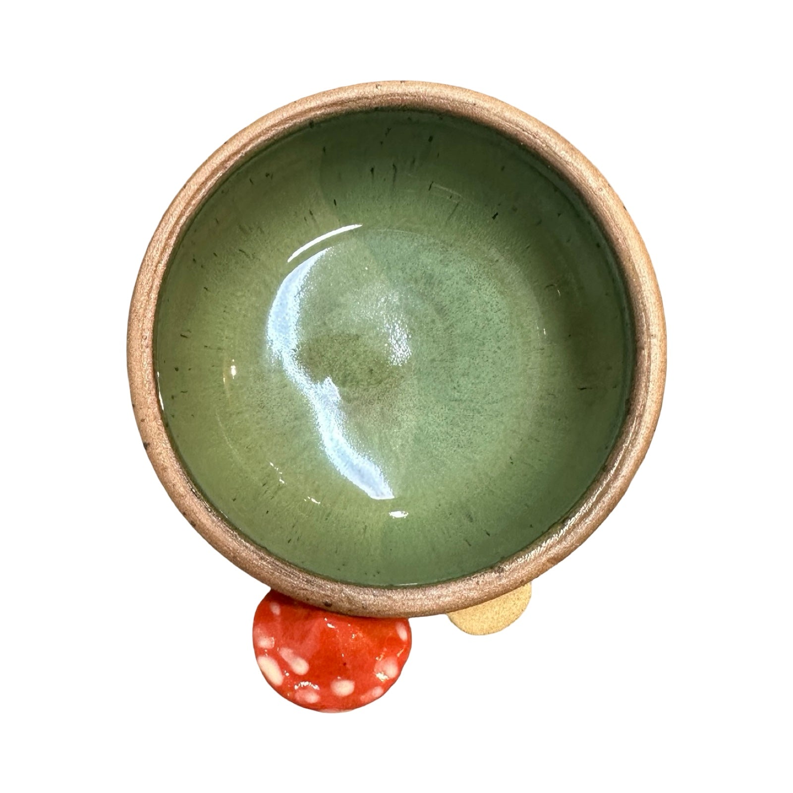 Ceramic trinket dish with green interior and beige exterior on a white background.