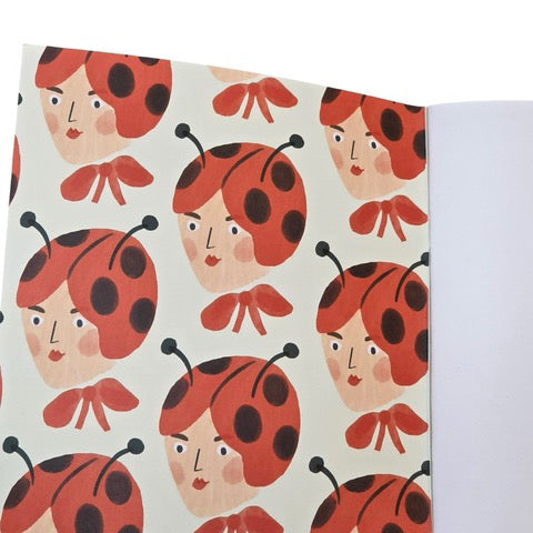 These gorgeous notebooks feature a lady's head wearing a ladybird hat and a large red bow around her neck.