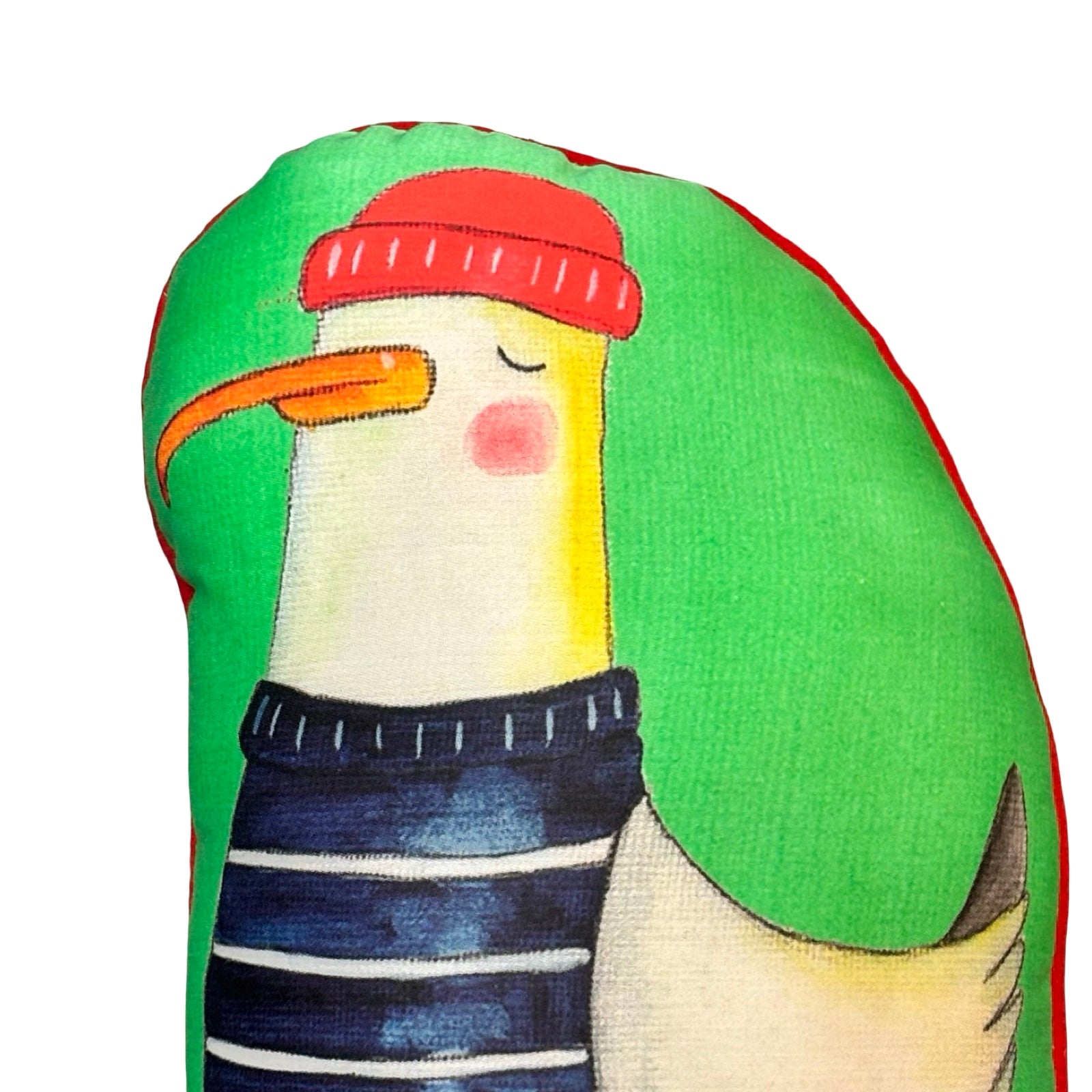 Stuffed toy penguin with a red hat and striped pants on a green background.