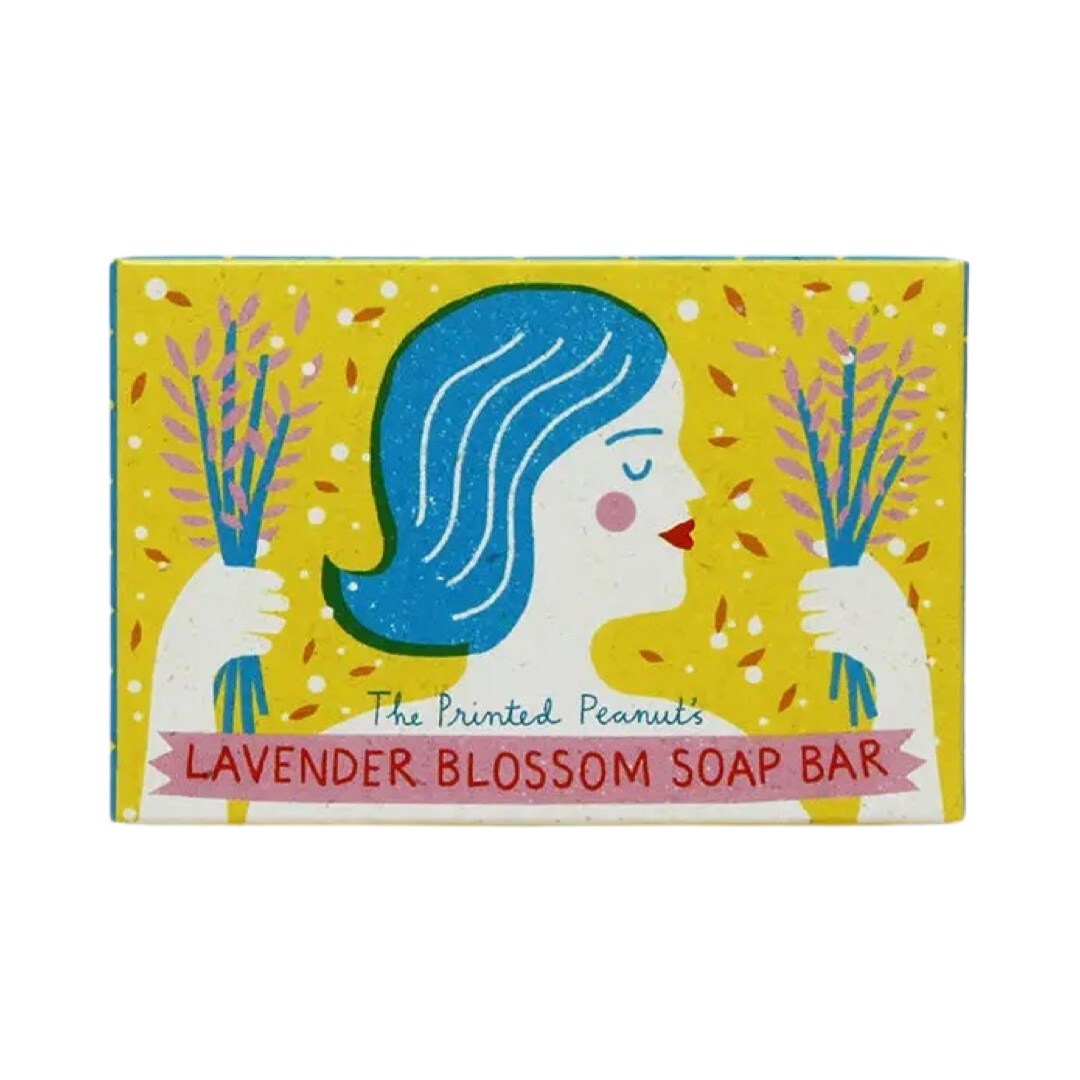 Soap bar with a colorful packaging featuring a woman's face and lavender blossoms on a white background.