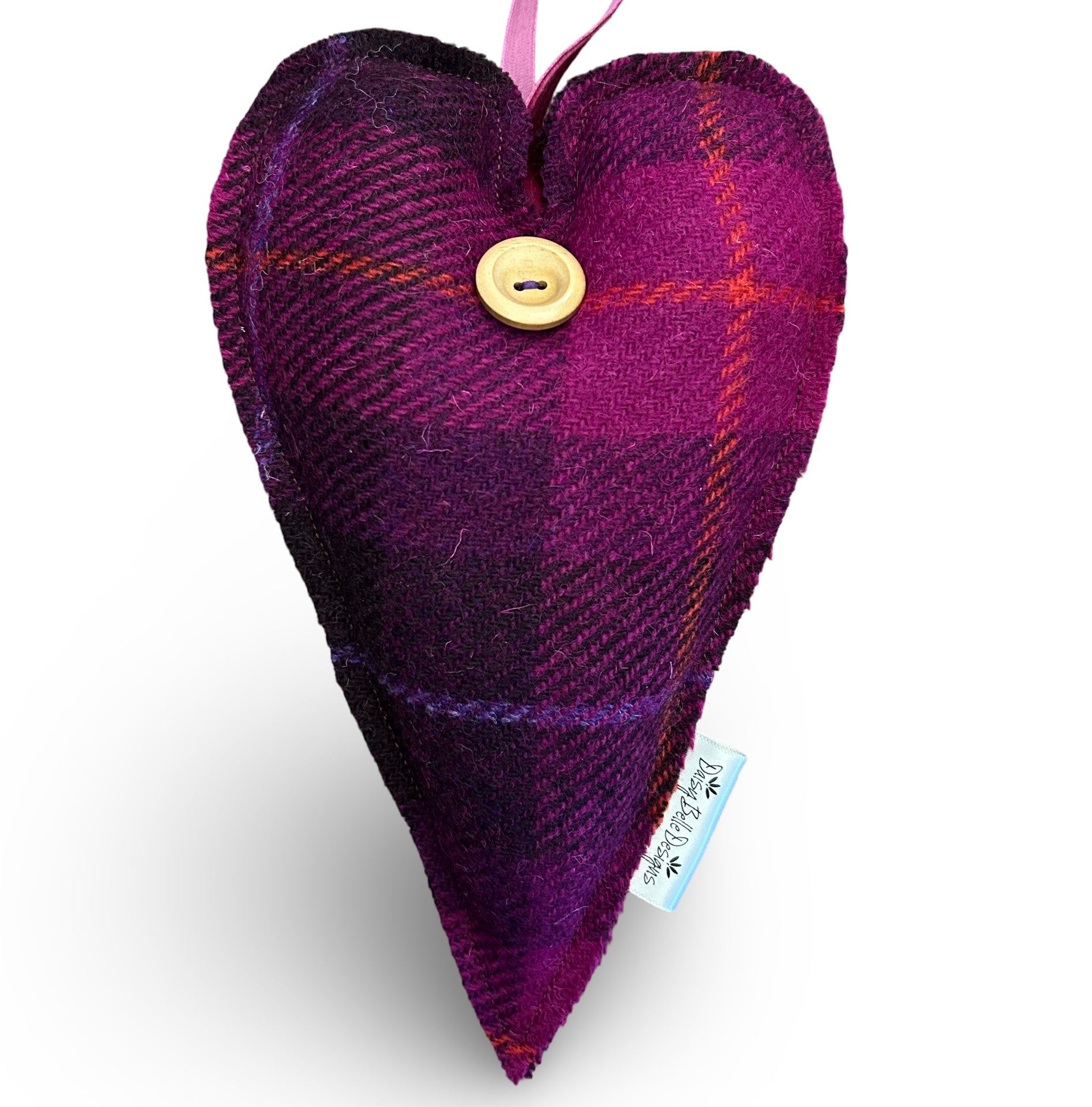 Large Harris tweed lavender heart in dark purple and cerise. The heart has a wooden button and a dark pink velvet ribbon loop.