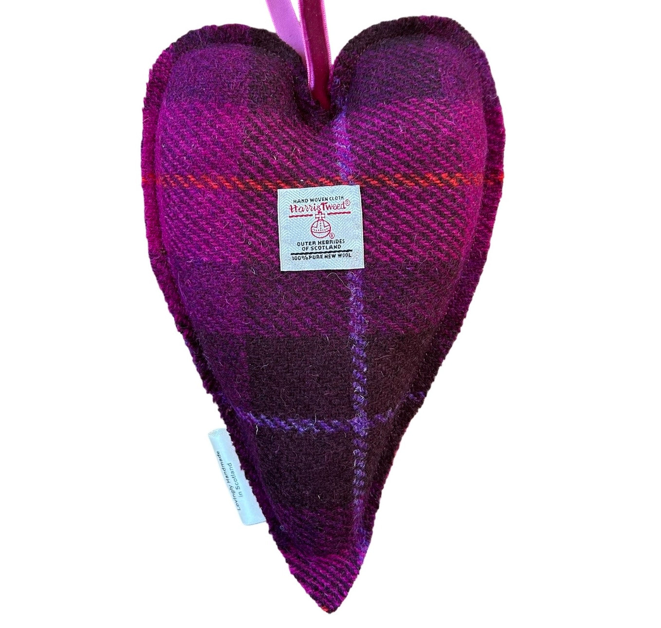 Showing the reverse of the large purple and cerise tweed lavender heart. There is a Harris tweed Orb label hand sewn onto the back of the heart.