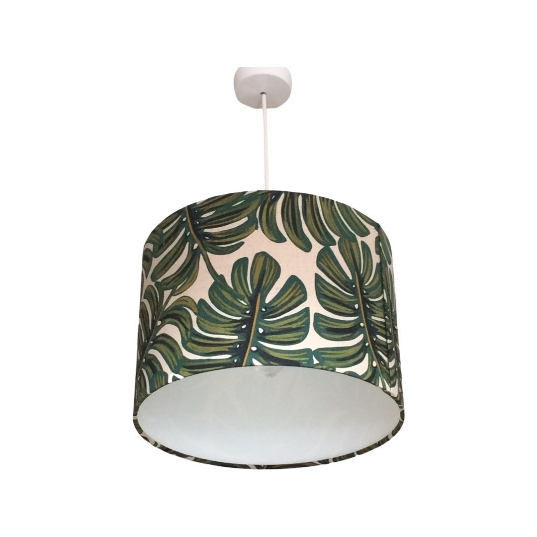 Drum lampshade covered in gorgeous green and natural monstera leaf canvas fabric.