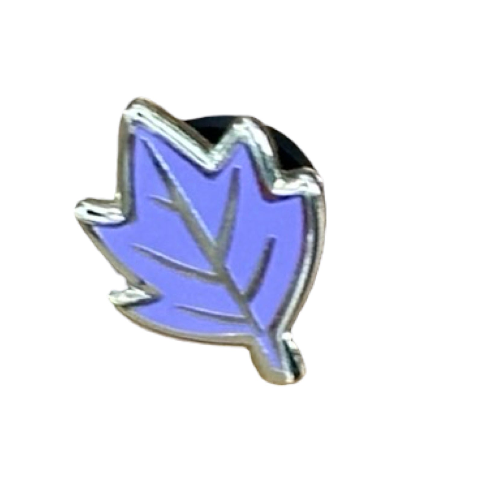 A set of three leaf-shaped enamel pin badges, one green, one orange and one lilac.
