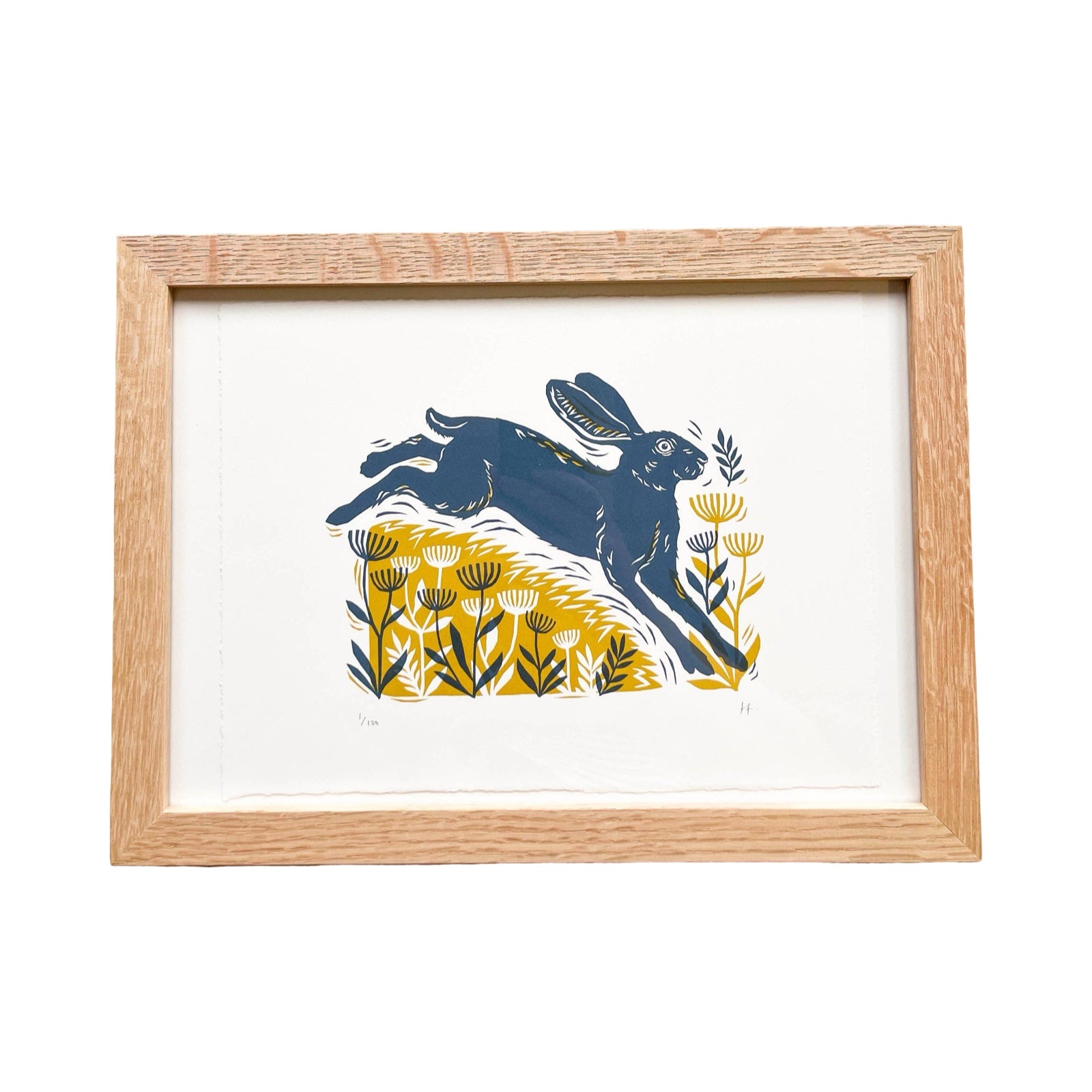 Framed artwork with a blue hare and yellow flowers design on a white background.