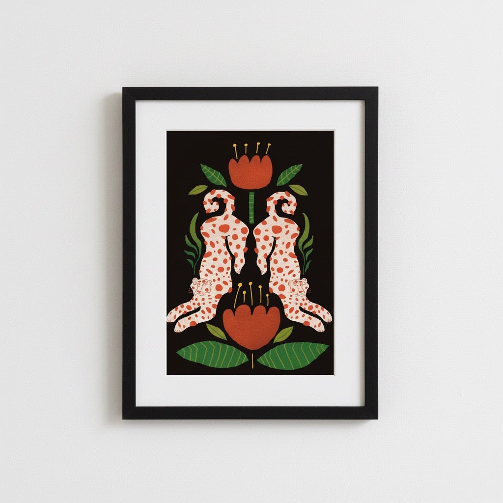 Framed artwork with two polka-dotted animals below a red flower on a white wall.