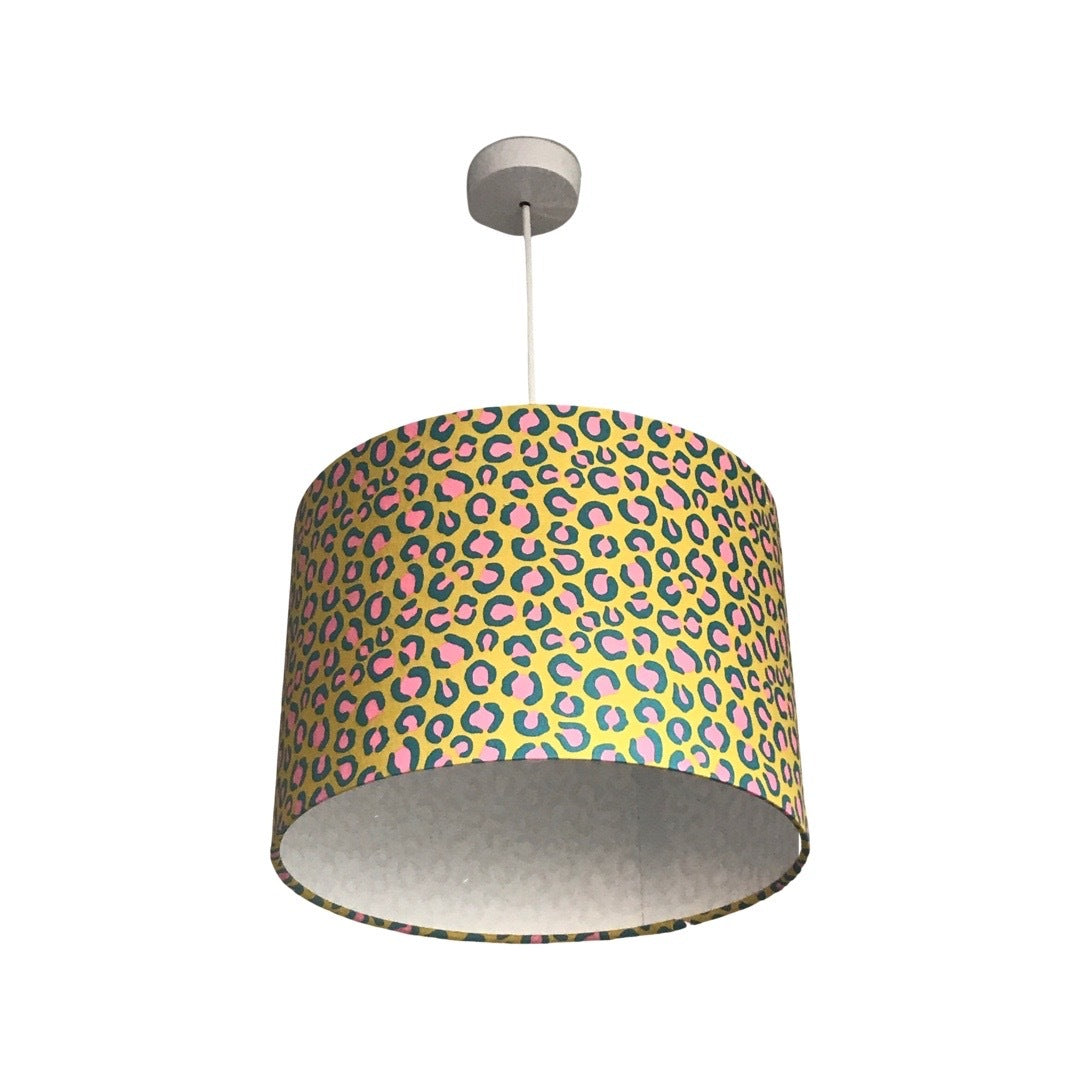 Drum lampshade covered in bright yellow leopard print cotton fabric with pink and blue detail