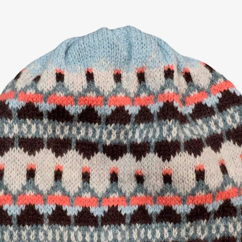 This blue, navy, pink and white striped woollen hat is handmade using only the softest Scottish spun lambswool.
