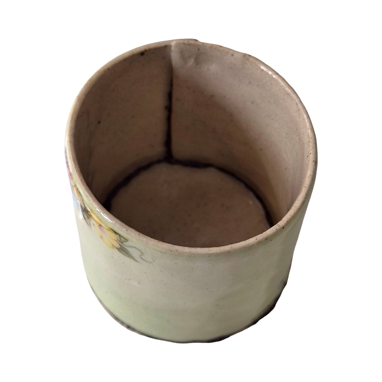 Ceramic planter with floral design on a white background.