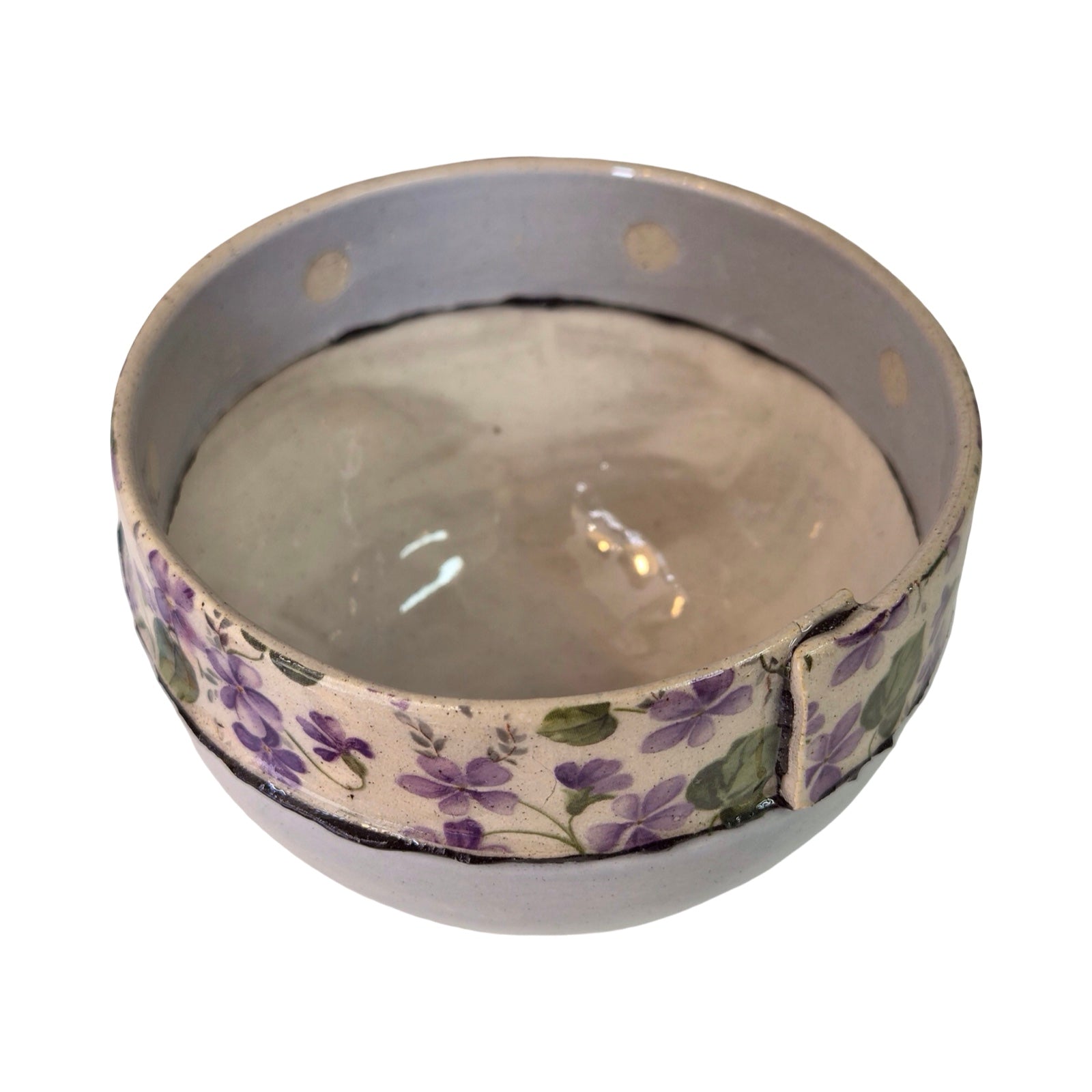 Round ceramic dish with floral design on a white background.