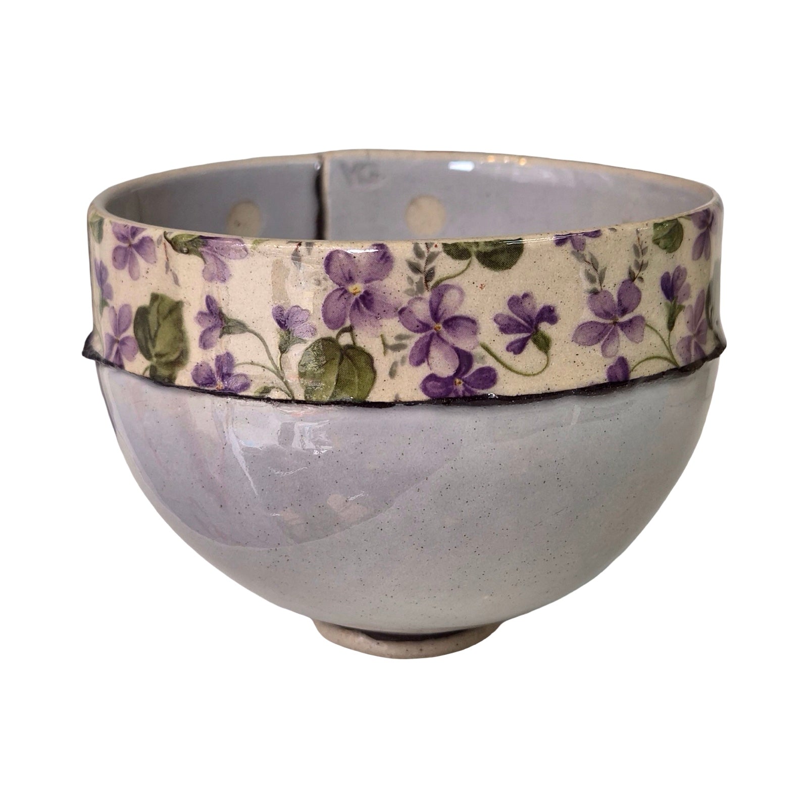 Ceramic bowl with floral patterned band on a white background.