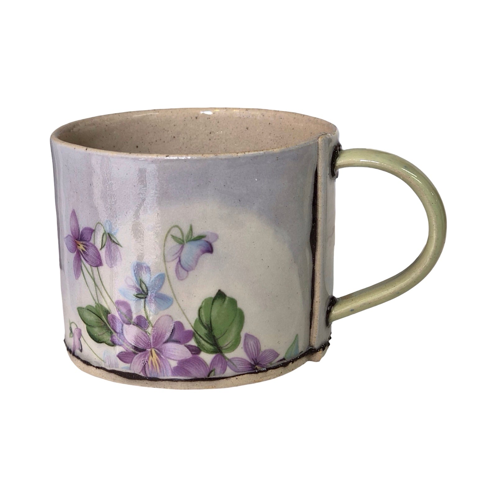 Ceramic mug with floral design on a white background.