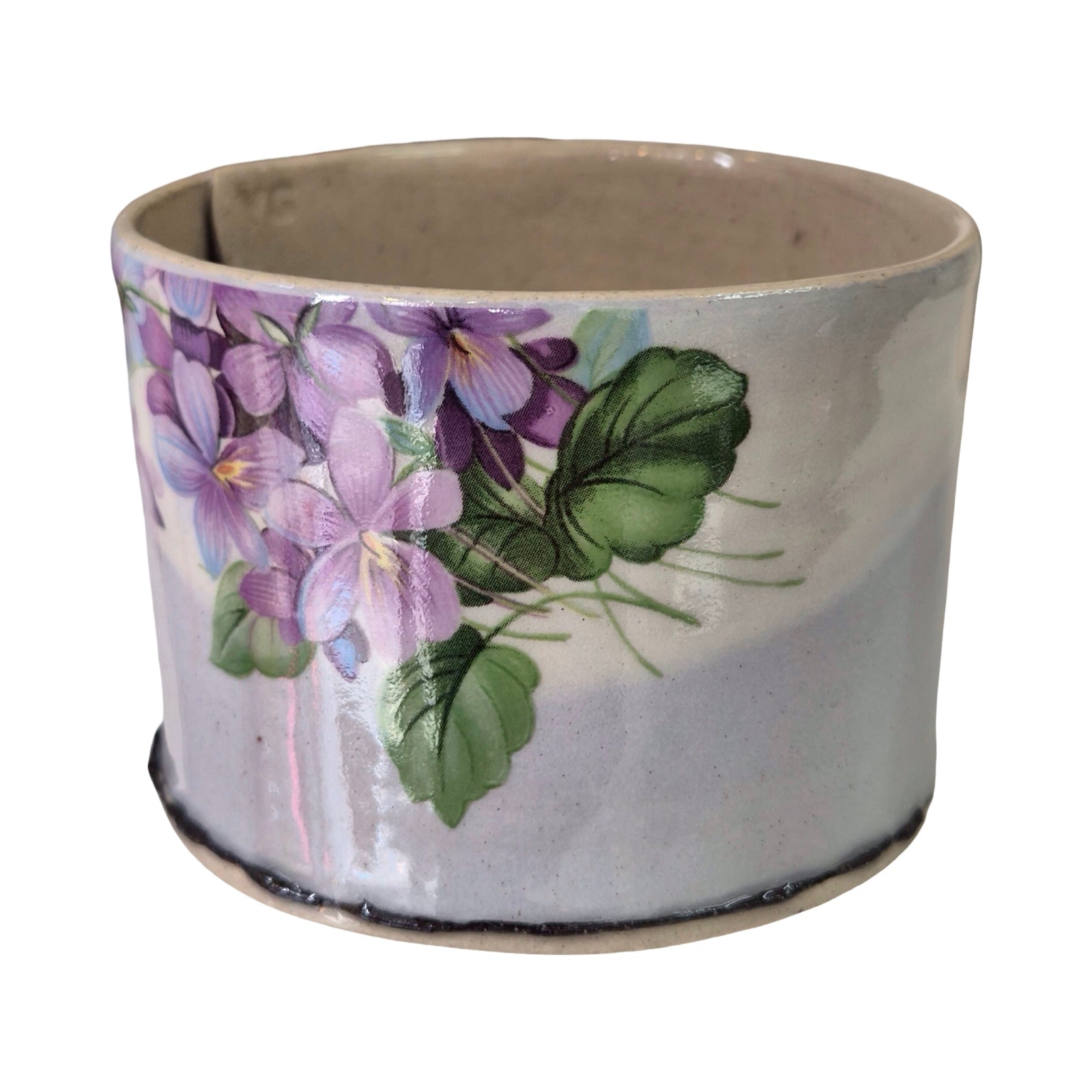 Ceramic pot with floral design on a white background.