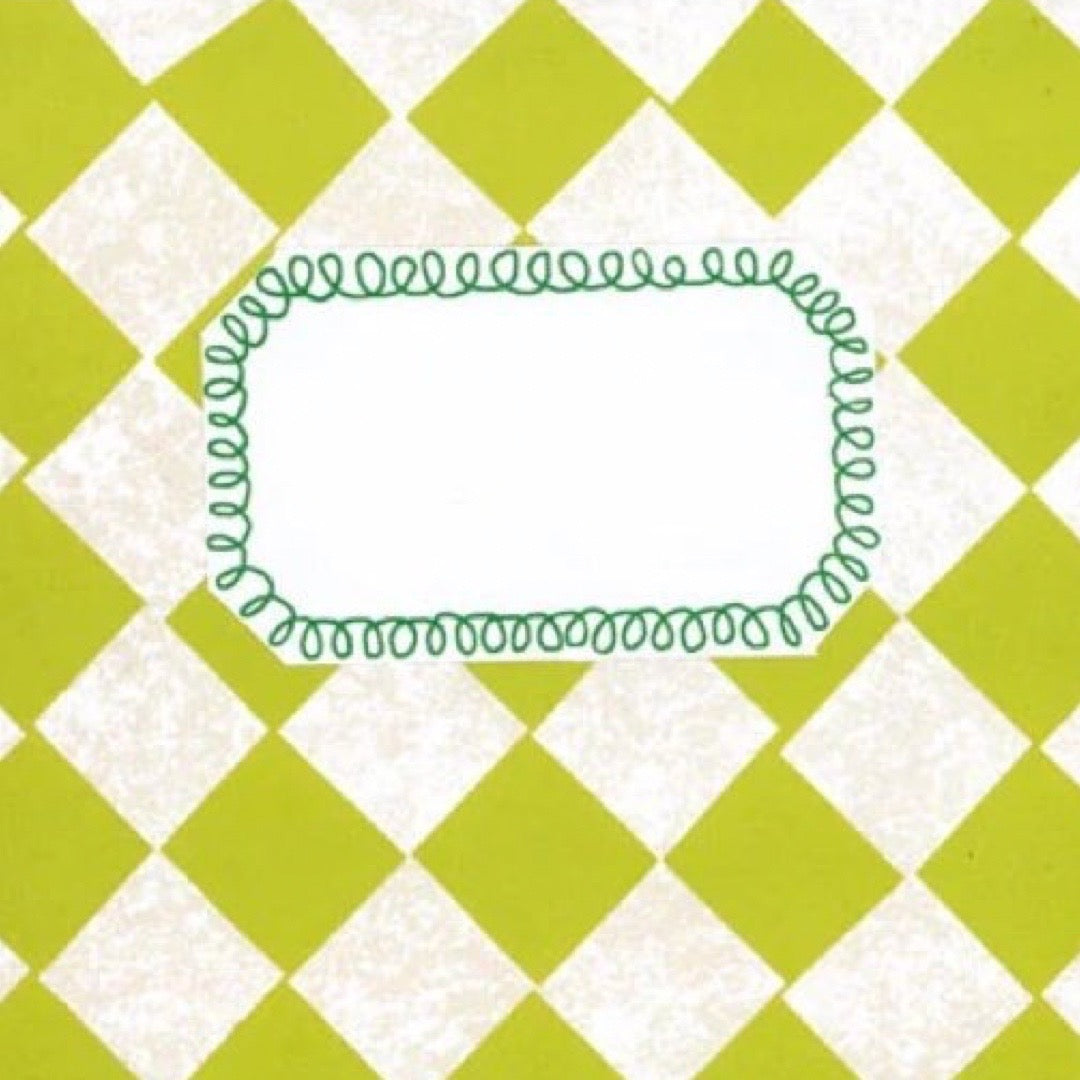 A close up of a notebook with a green hand-drawn scalloped border around a blank white cemtre, set against a lime green and off-white diamond patterned background.