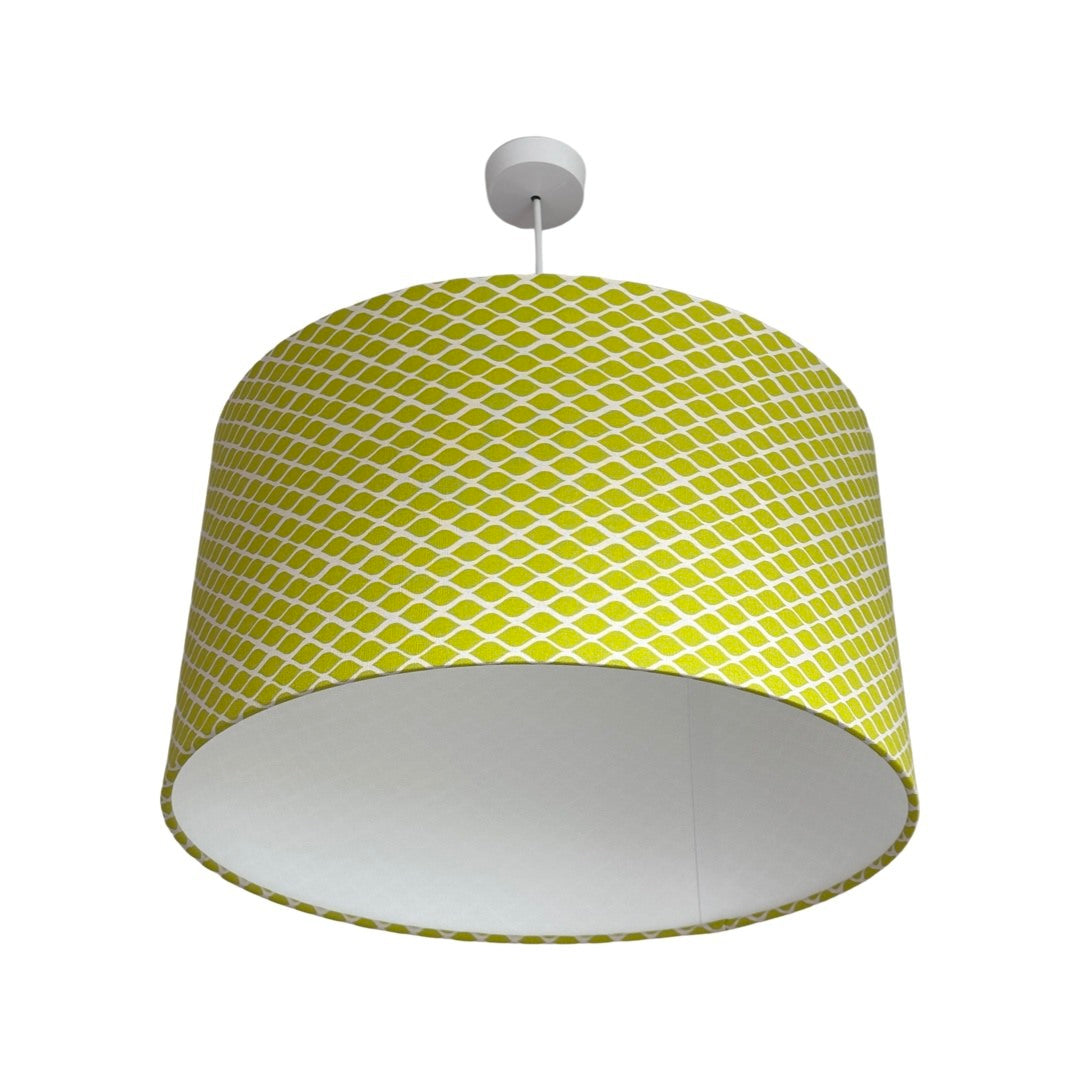Drum lampshade covered in bright lime canvas fabric with a white diamond pattern