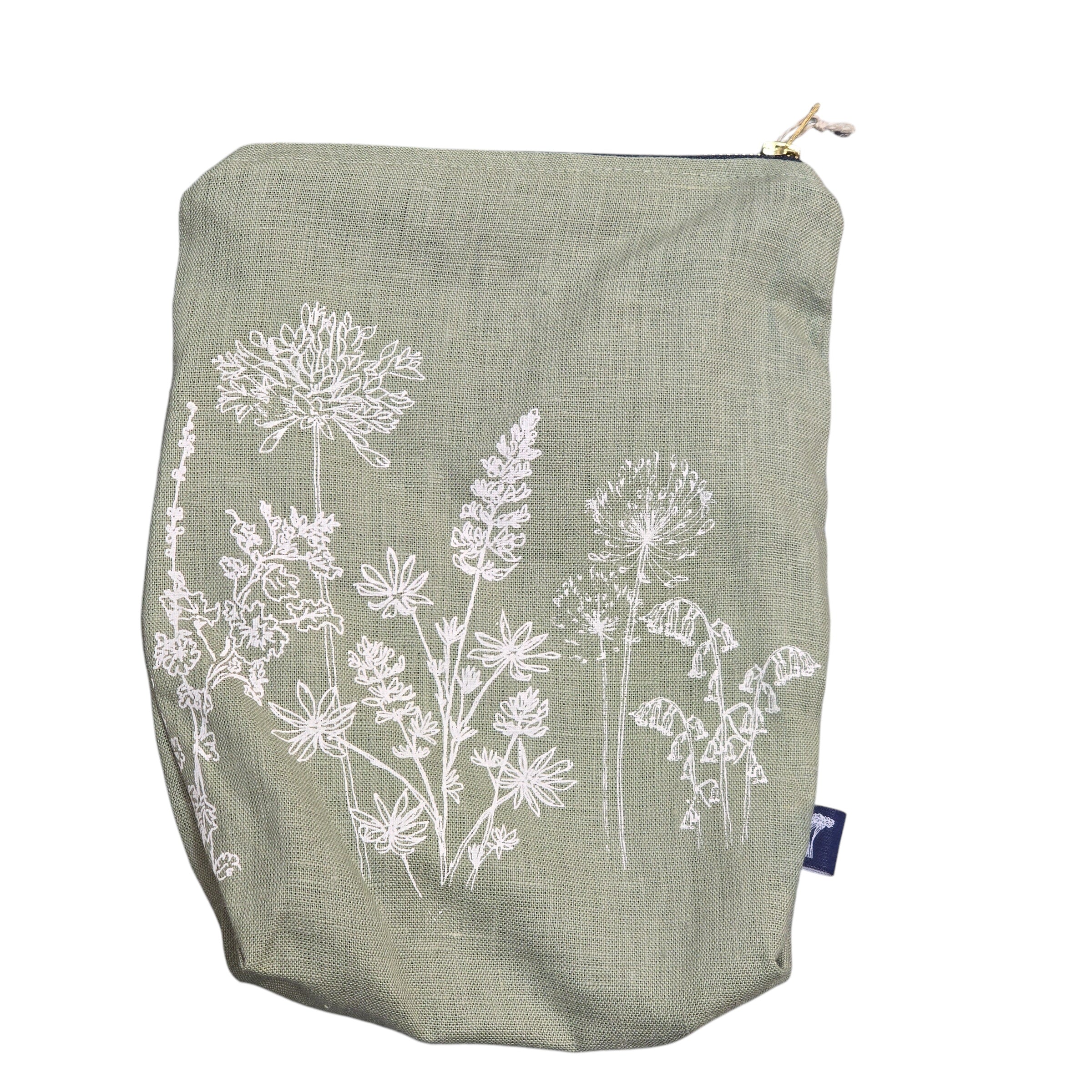 Screen-printed linen toiletry bags with a soft waterproof lining and a brass zip.