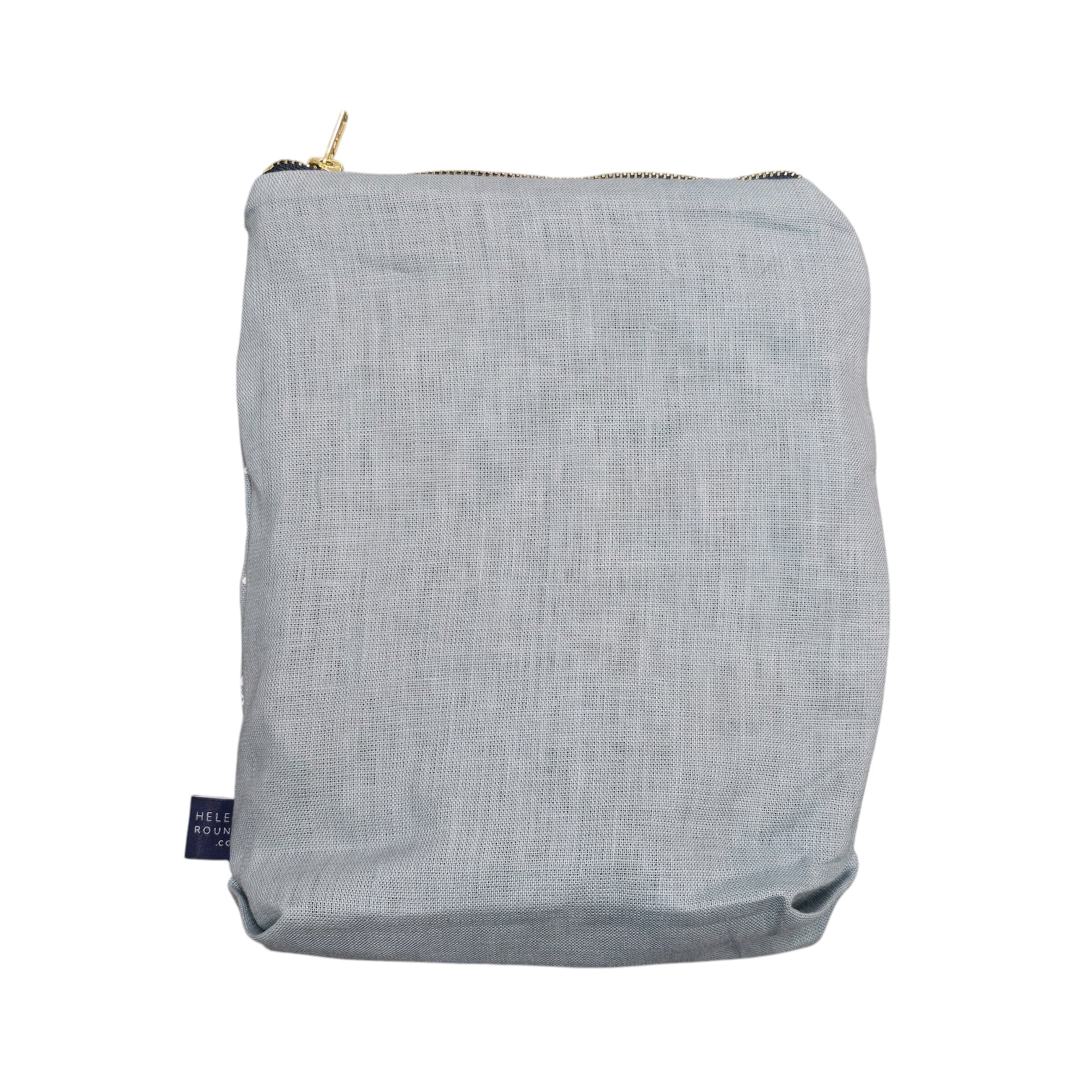Screen-printed linen toiletry bags with a soft waterproof lining and a brass zip.