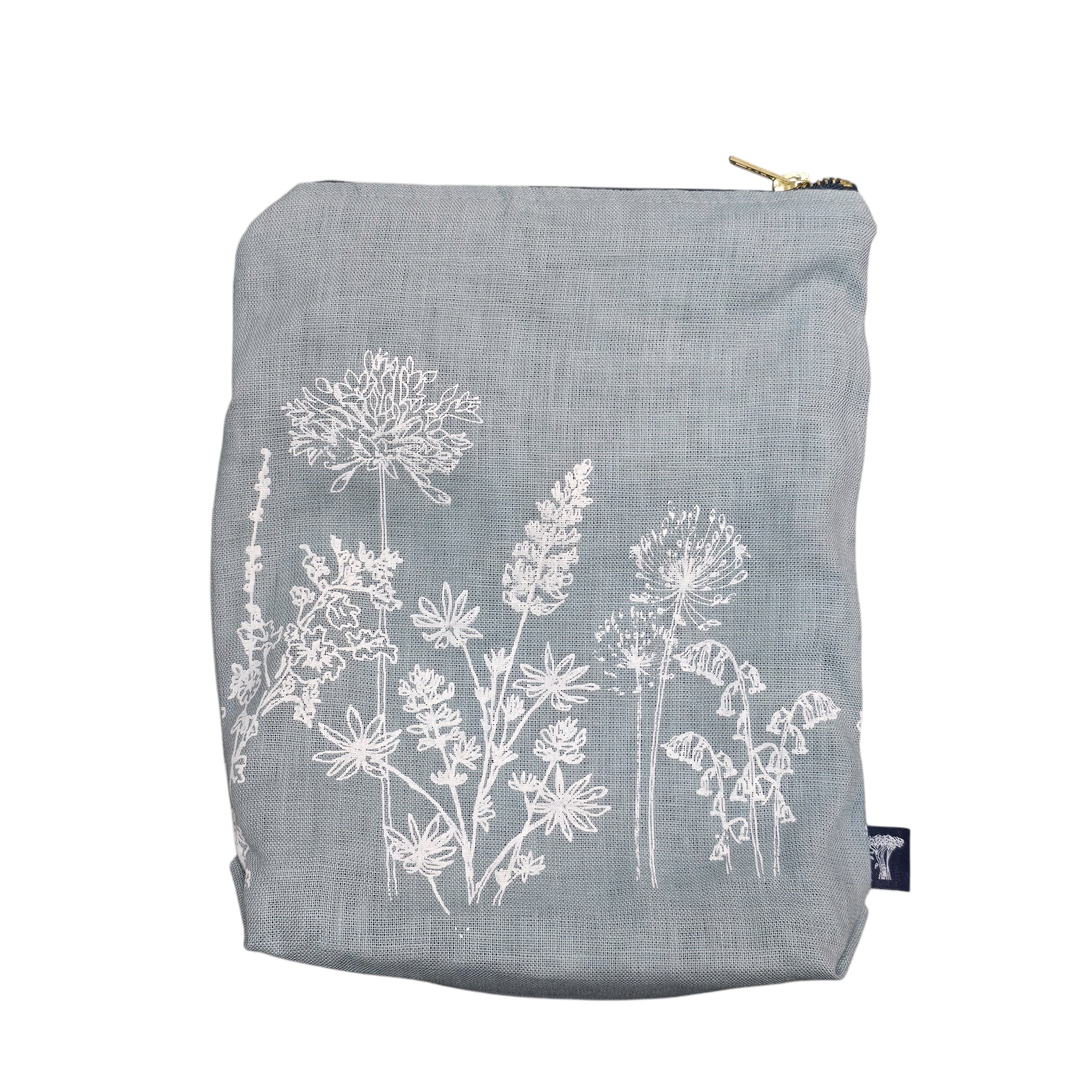 Screen-printed linen toiletry bags with a soft waterproof lining and a brass zip.