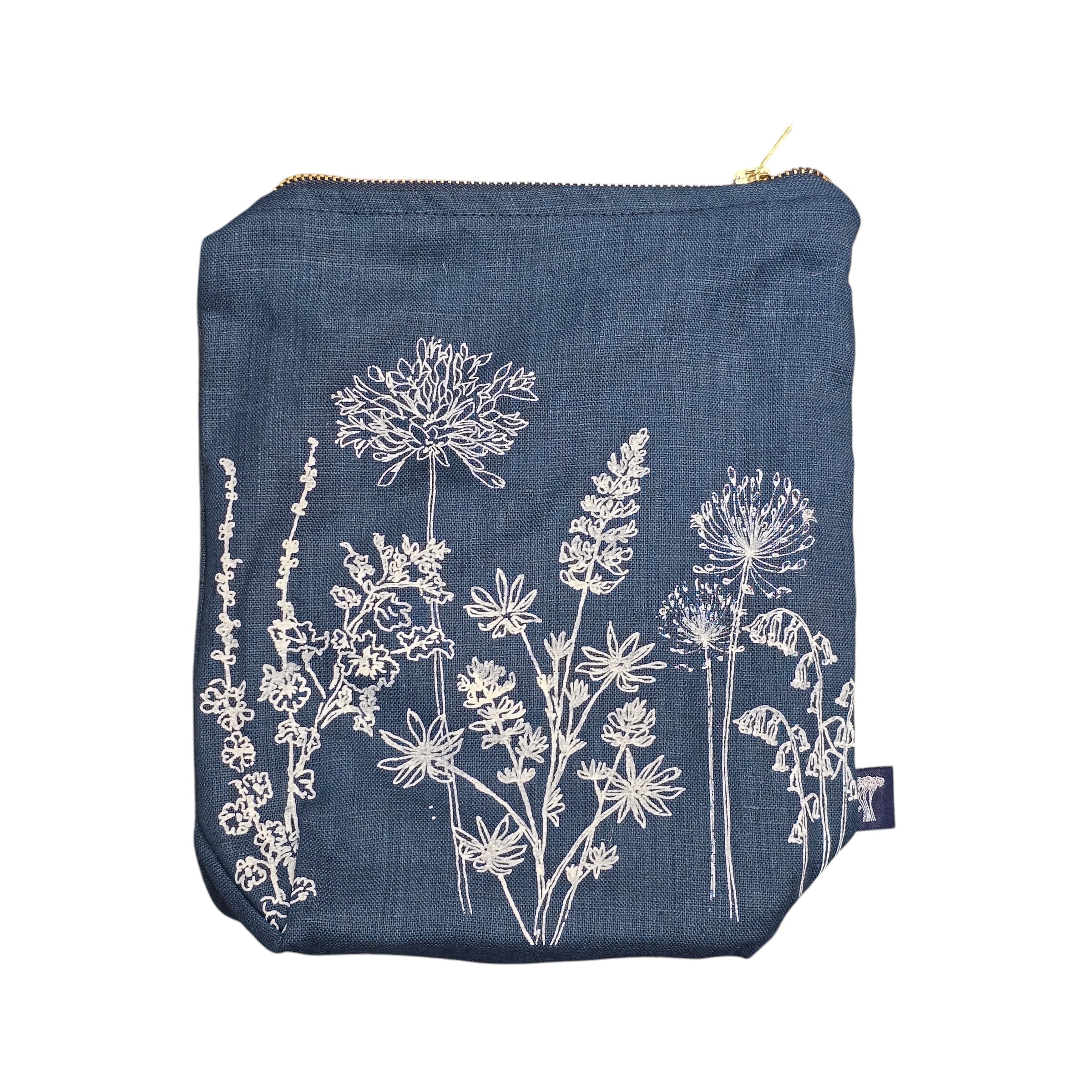 Screen-printed linen toiletry bags with a soft waterproof lining and a brass zip.