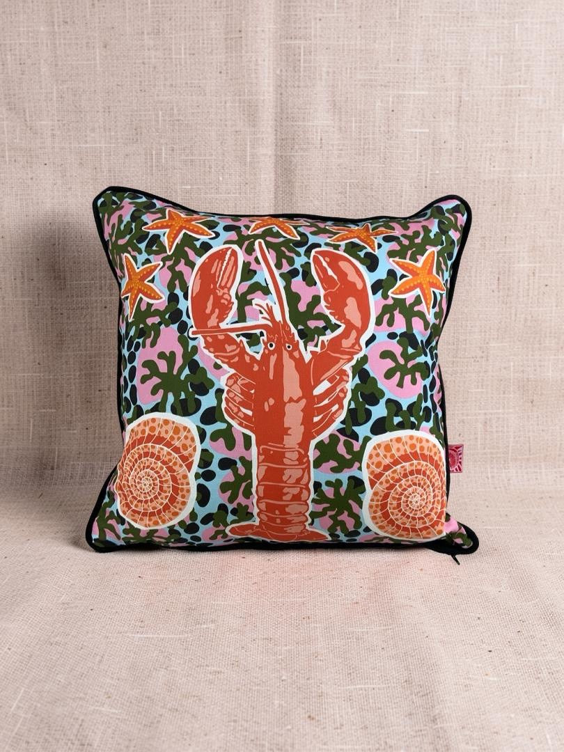 Decorative pillow with a lobster design on a beige background.