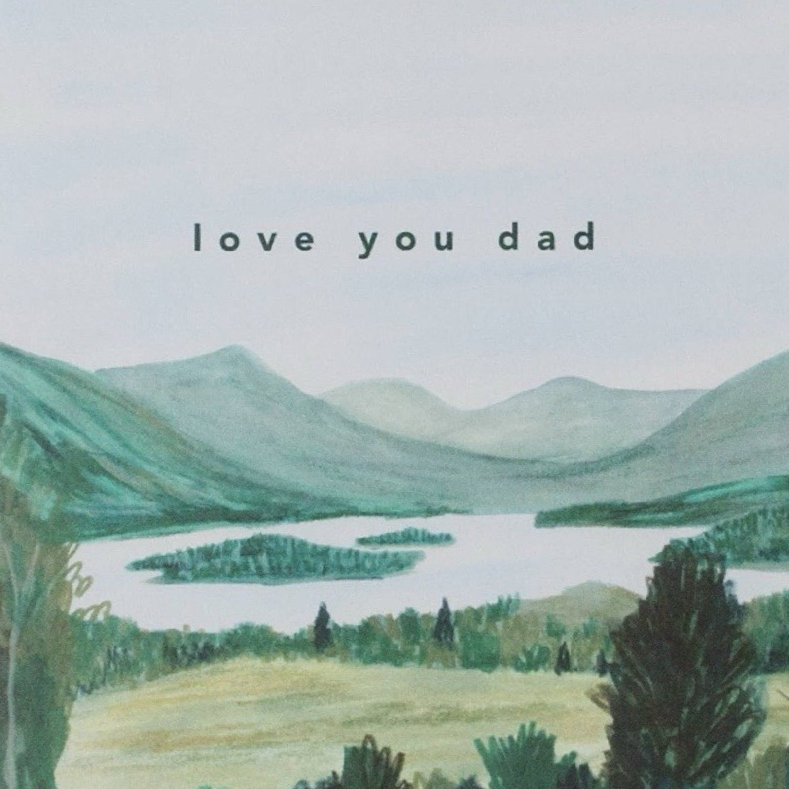 Father's Day card featuring an illustration of a loch surrounded by countryside with mountains behind, and the text 'Love You Dad'.