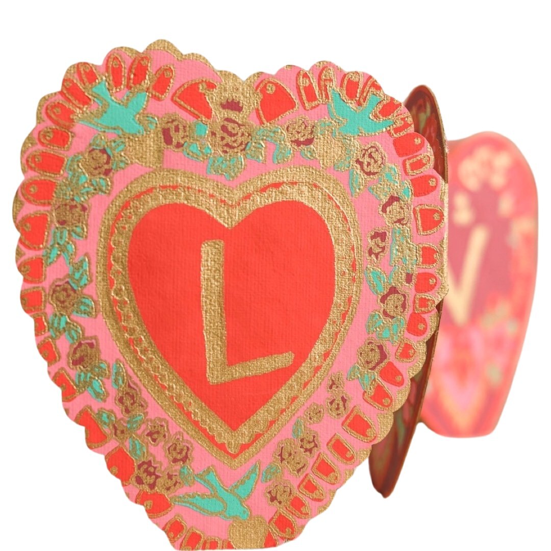 A heart-shaped concertina card with the individual letters LOV in the centre of each concertina.