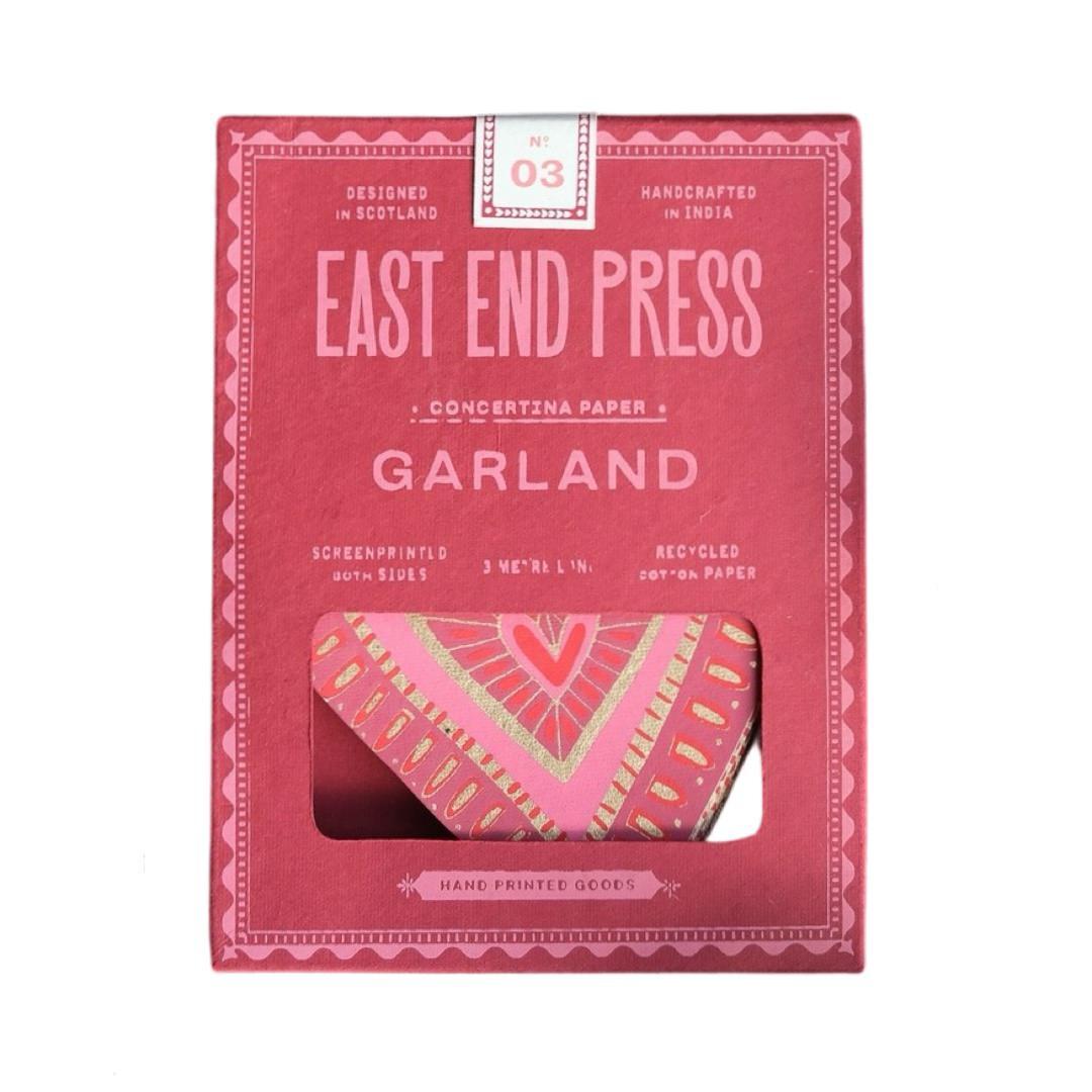 A deep pink paper packet for a love heart-shaped concertina garland.