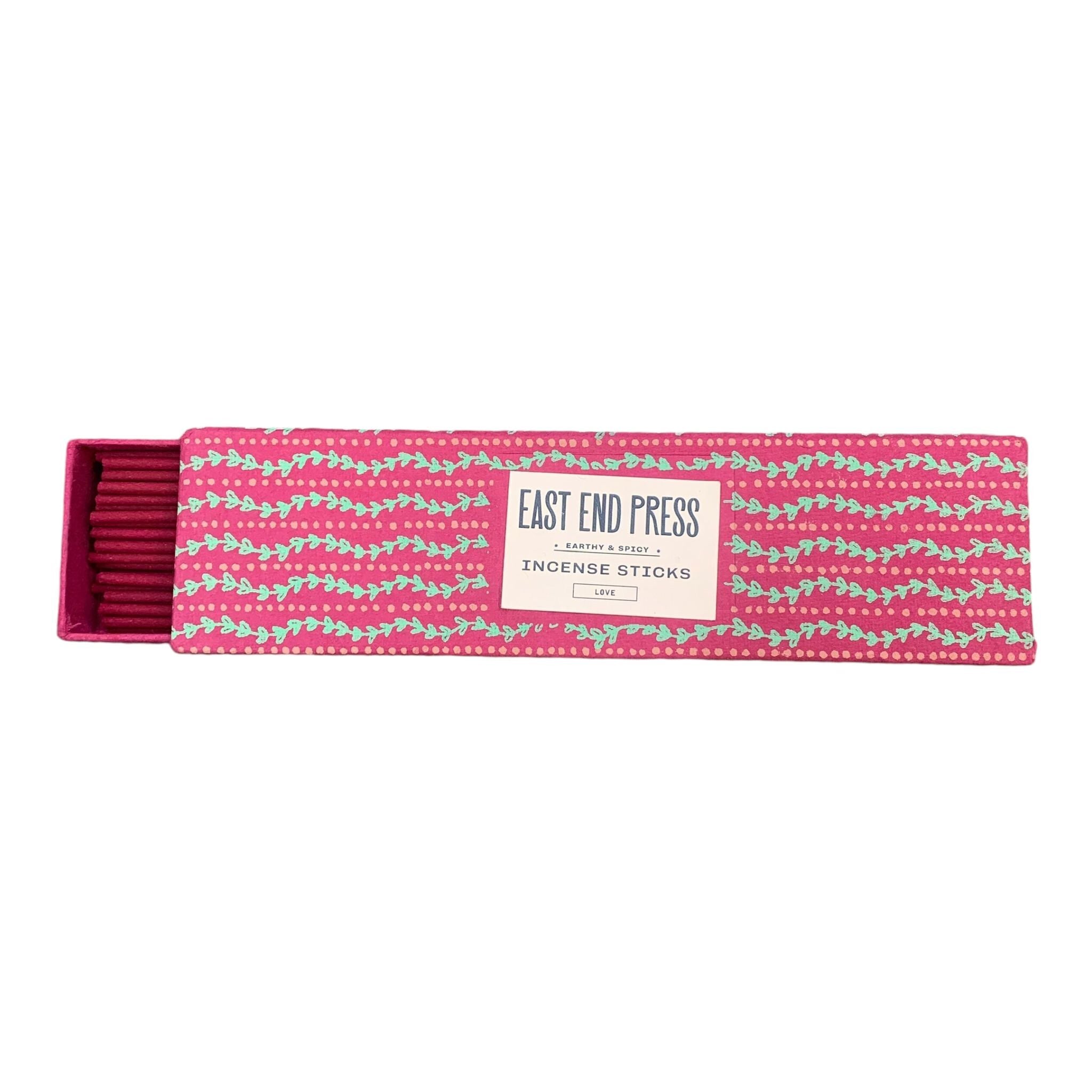 Pink box with green wavy lines holding love incense sticks.
