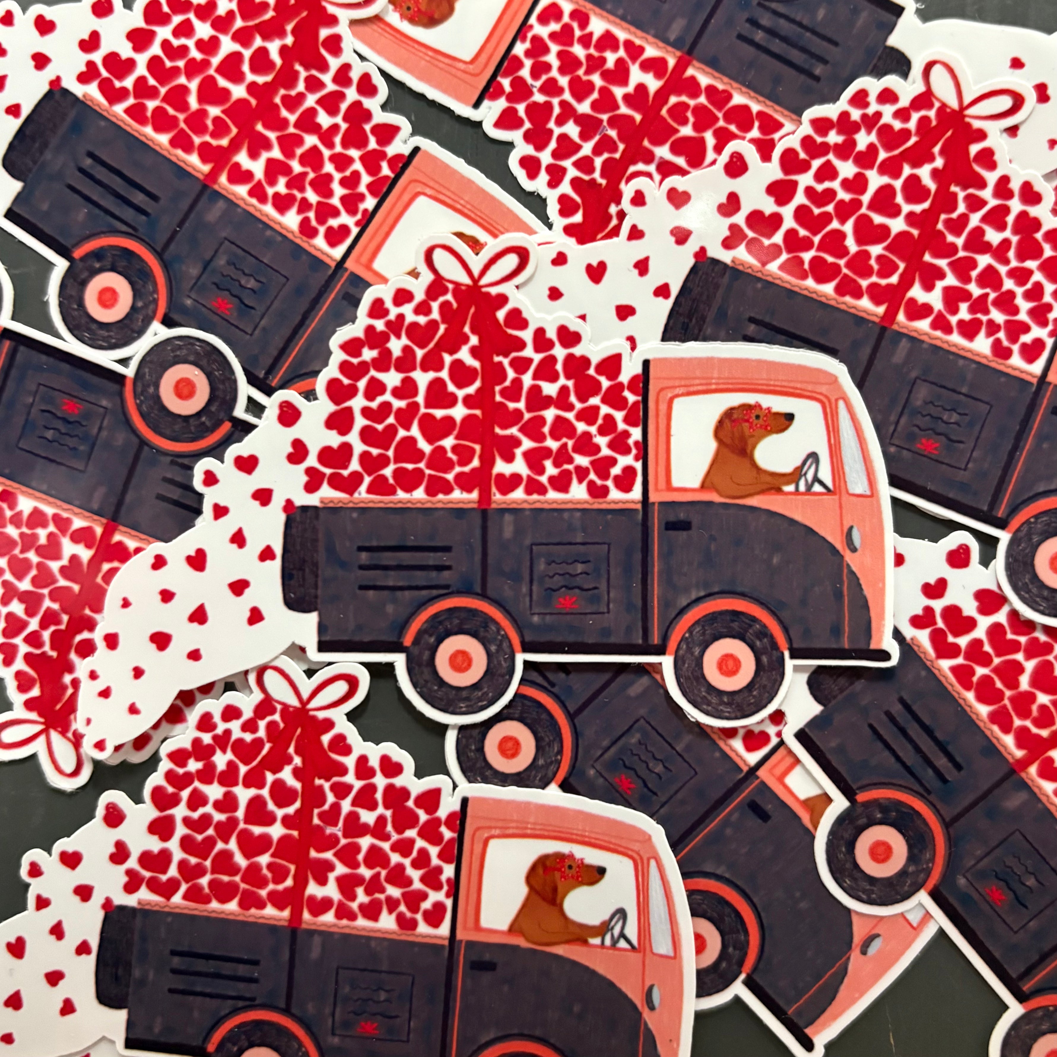 Stickers of trucks with hearts and a dog driver in a pile.