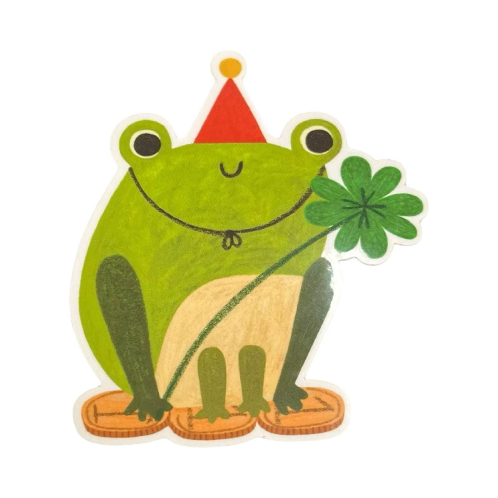 A vinyl sticker of a frog wearing a red pointed hat holding a four-leaf clover, standing on three gold coins.