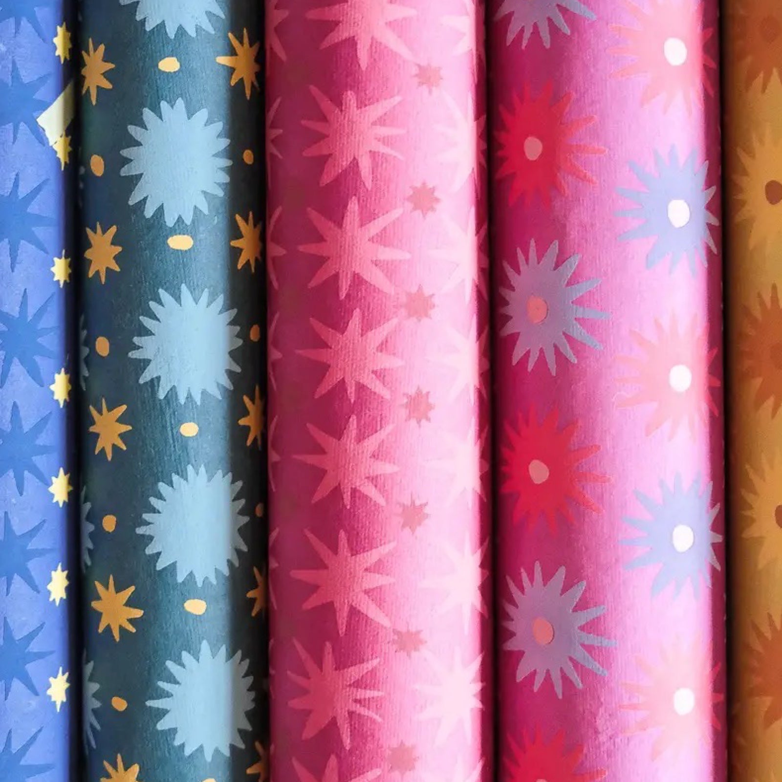 5 rolls of colourful hand printed wrapping paper.