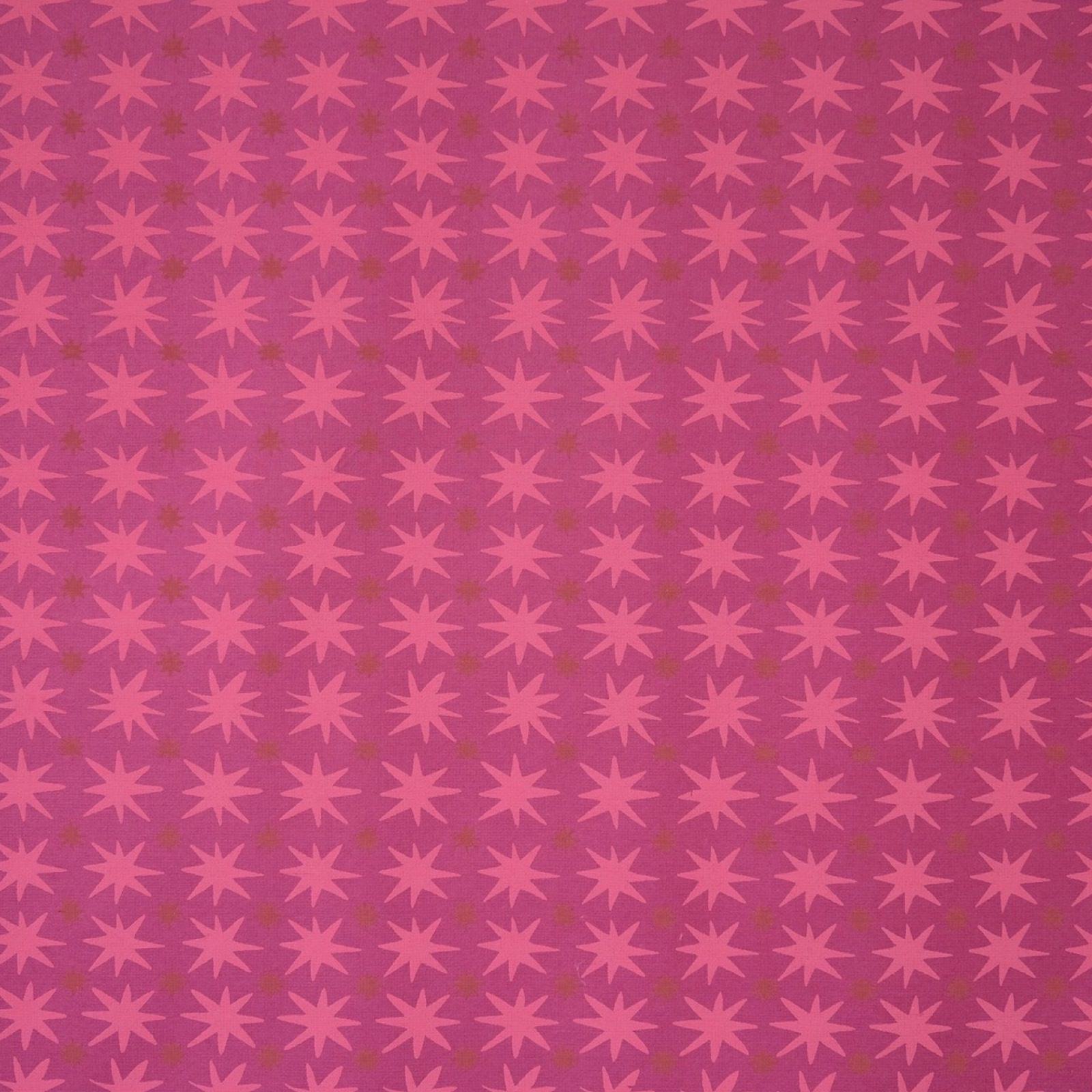 Wrapping paper with pink stars against a magenta background