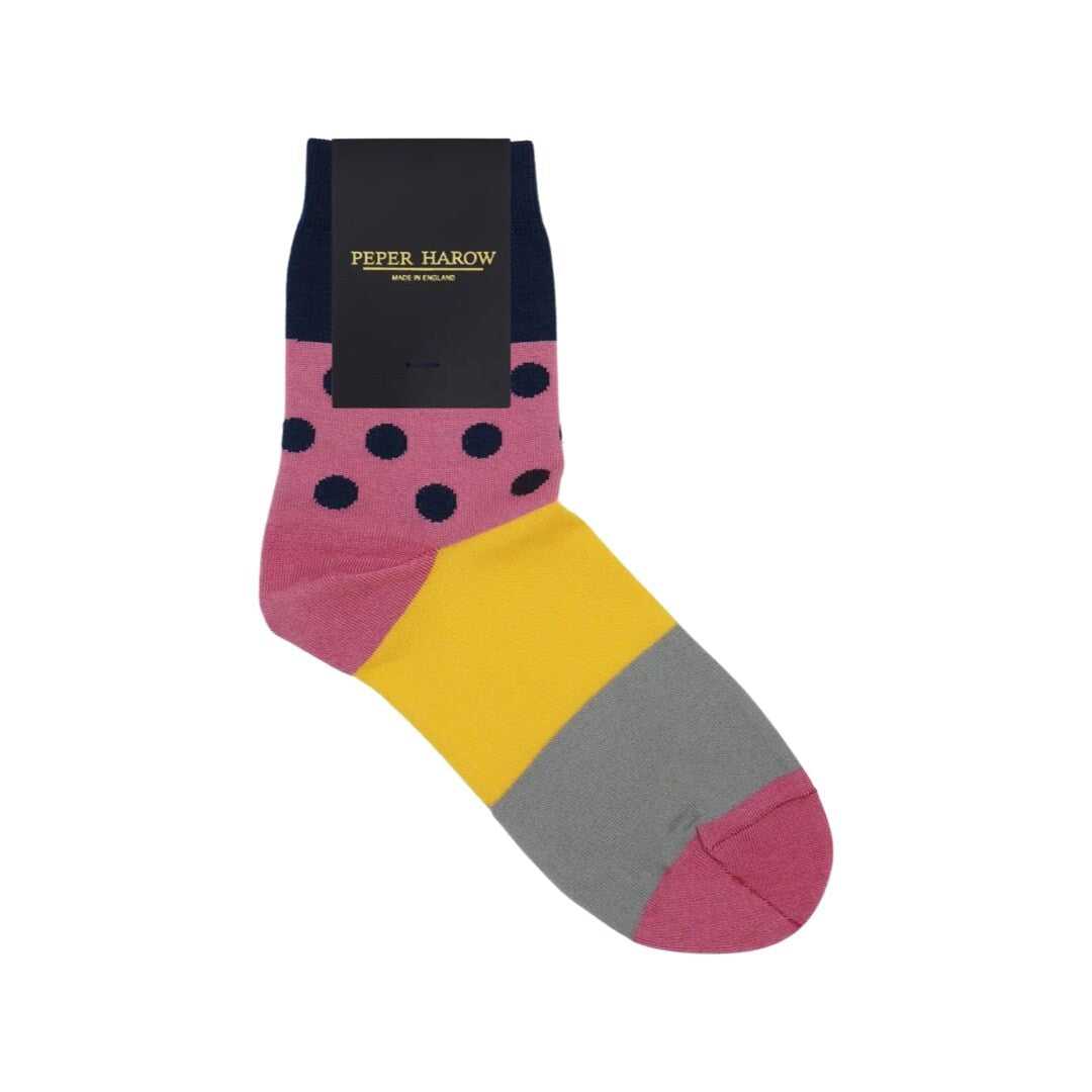Ladies socks with a solid navy cuff with pink and navy polka dots, and a yellow and grey sole.