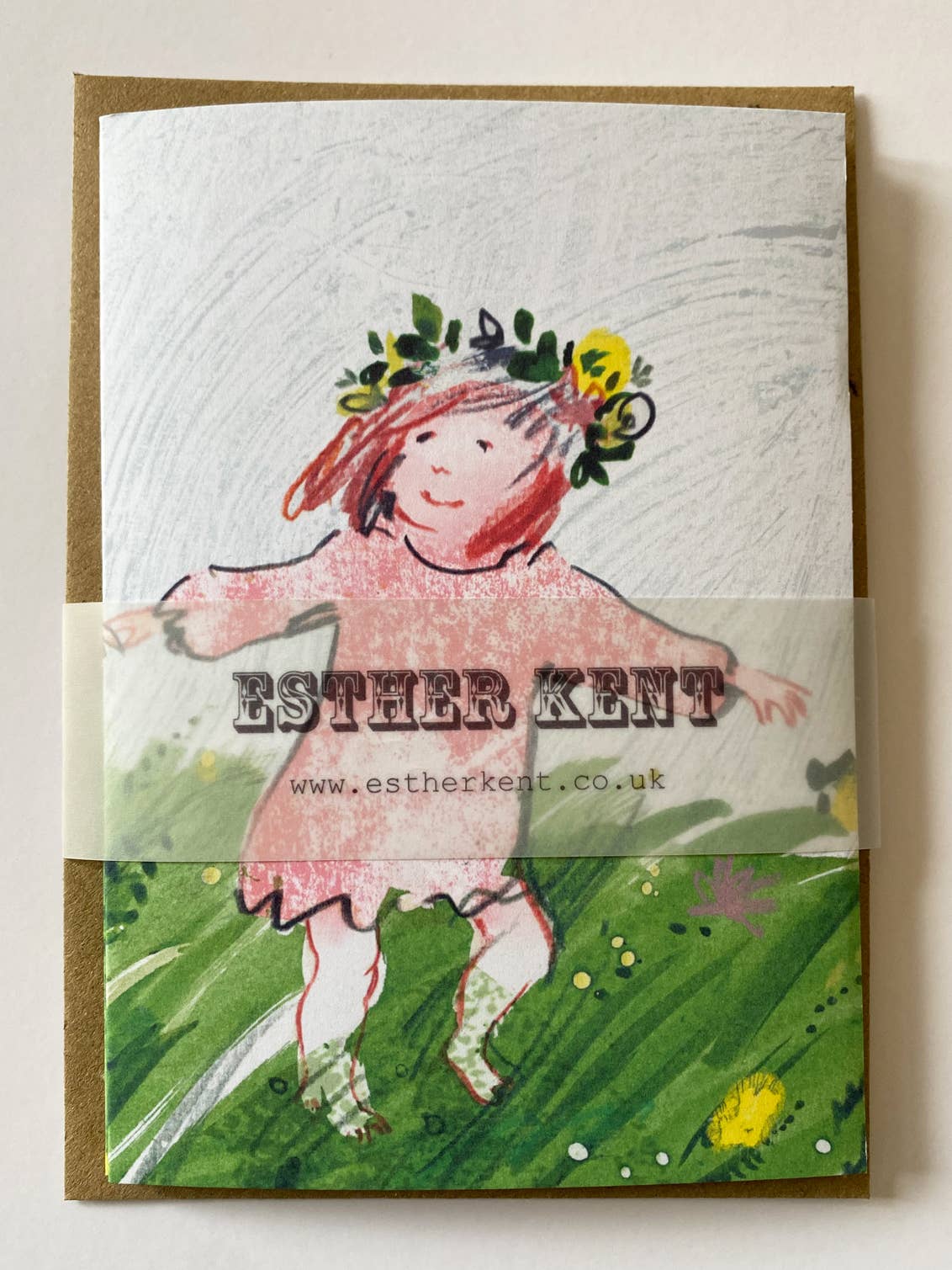 Card with illustration of a girl in a pink dress and floral headband, with 'Esther Kent' branding.