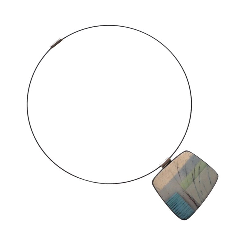 This pendent necklace is made from black porcelain casting slip layered with a white decorating slip and a ceramic decal, it is a wearable piece of art! The brooch features a turquoise, grey and cream abstract pattern, inspired by nature.