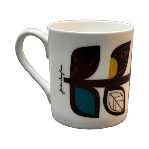 A white fine-bone china mug featuring a midcentury-inspired colourful leaf stem.