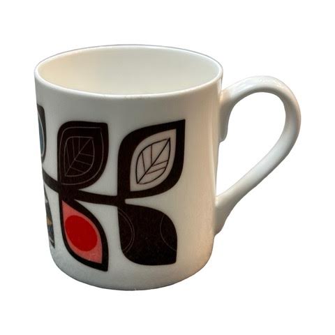A white fine-bone china mug featuring a midcentury-inspired colourful leaf stem.